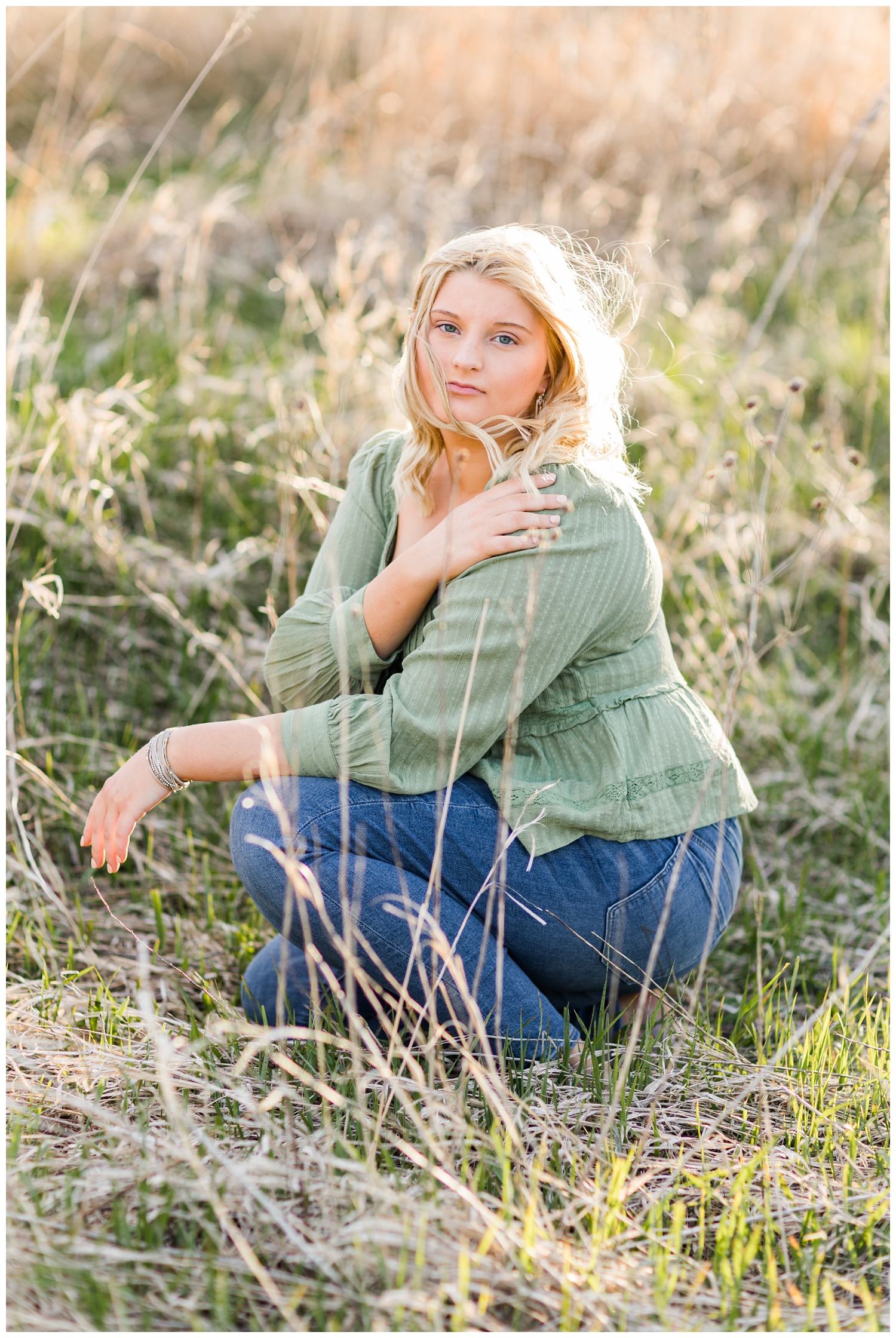 Abby sits in a grassy field during golden hour | CB Studio