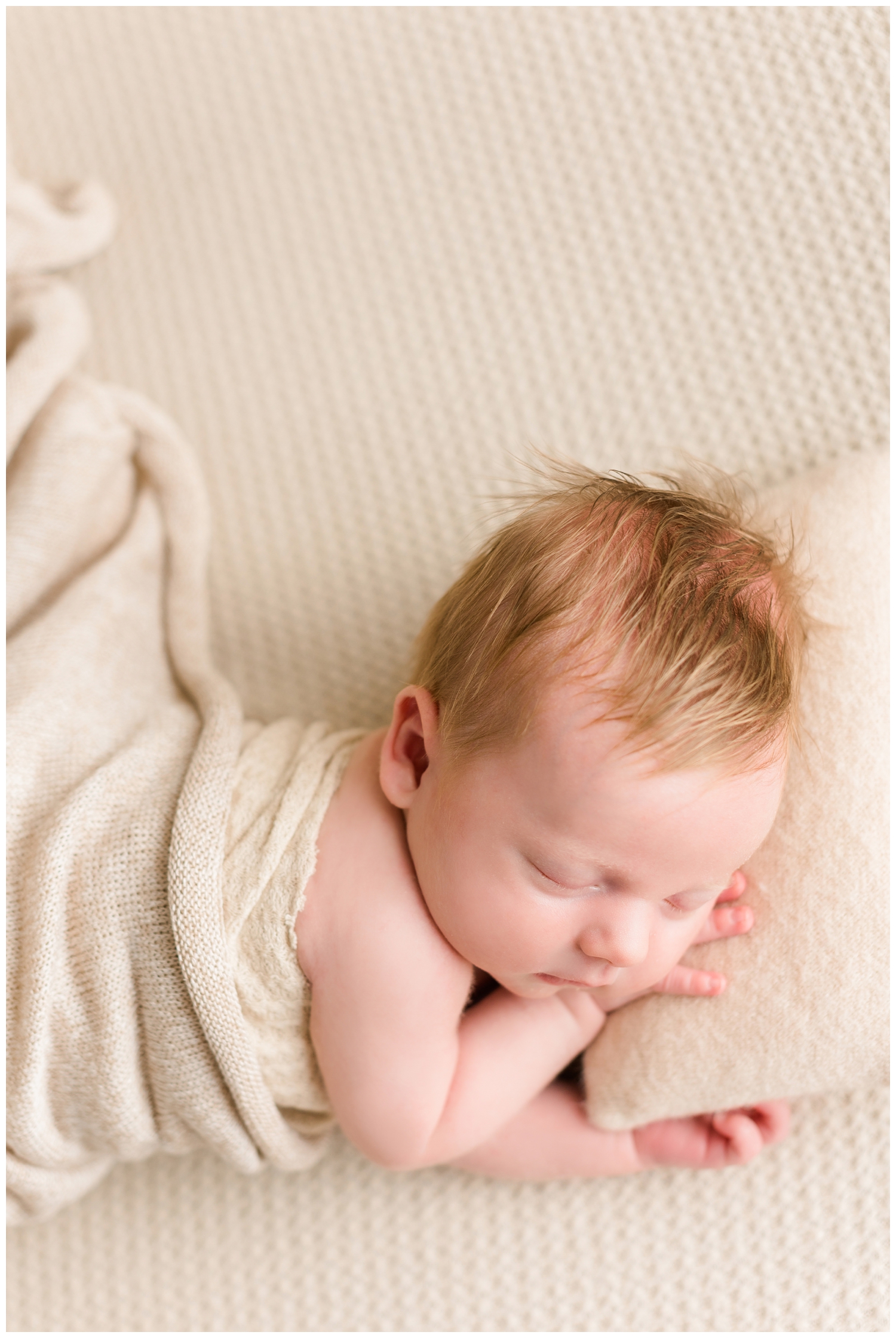 Newborn baby Brody sleeping soundly on a neutral pillow and blanket | CB Studio