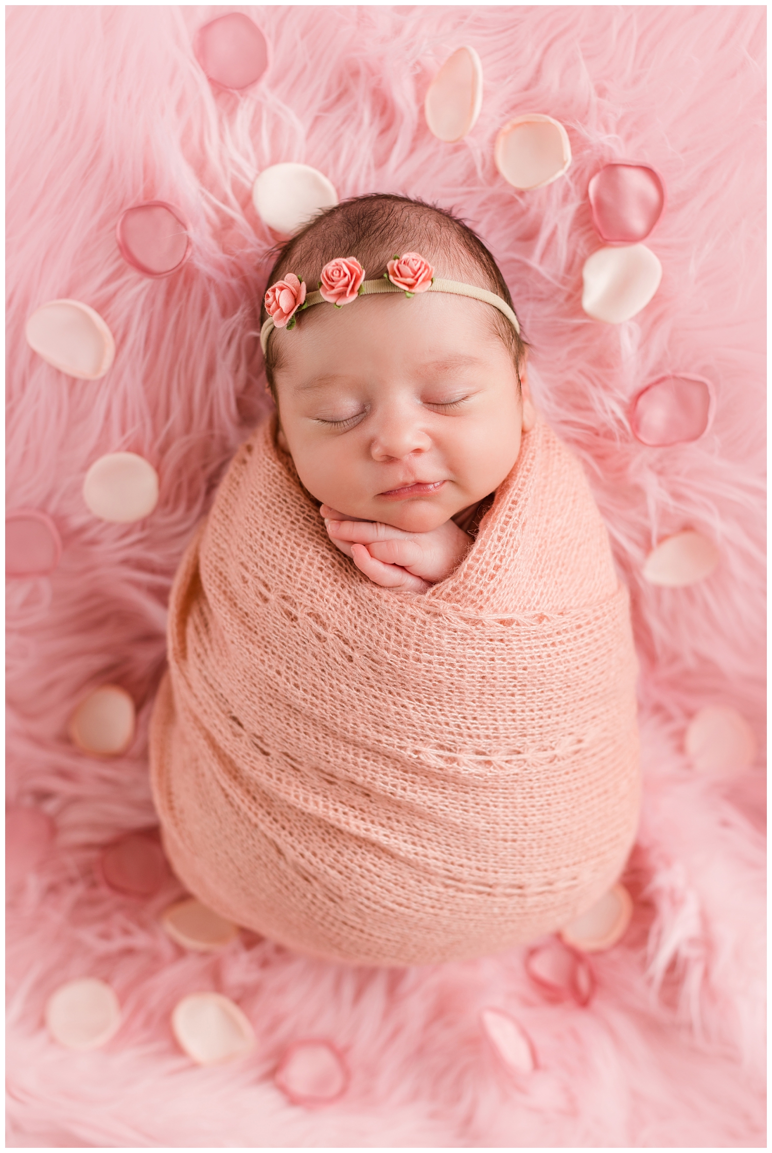 Baby Hazel dreaming sweetly all wrapped in pink and surrounded by rose petals | CB Studio