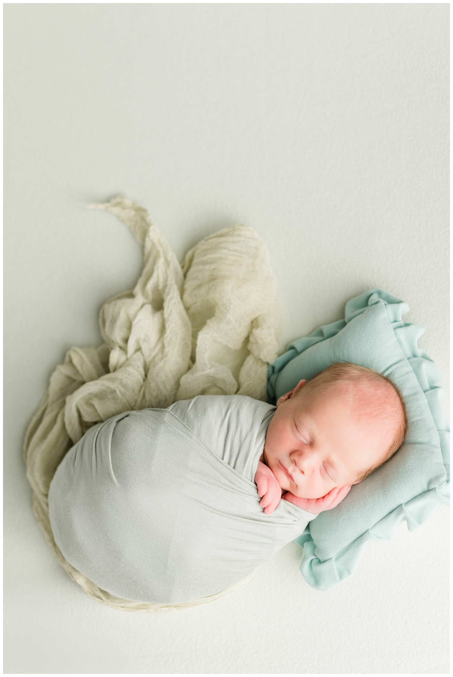 Newborn baby Lewis wrapped in sage green | CB Studio