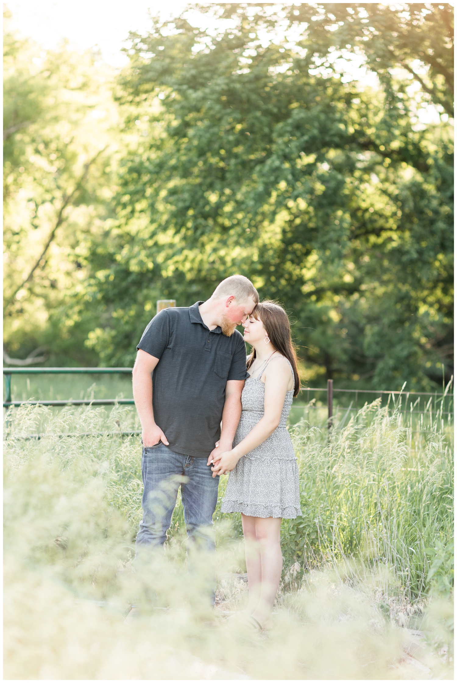 Jeremiah and Madeline embrace in a grassy pasture in Iowa | CB Studio