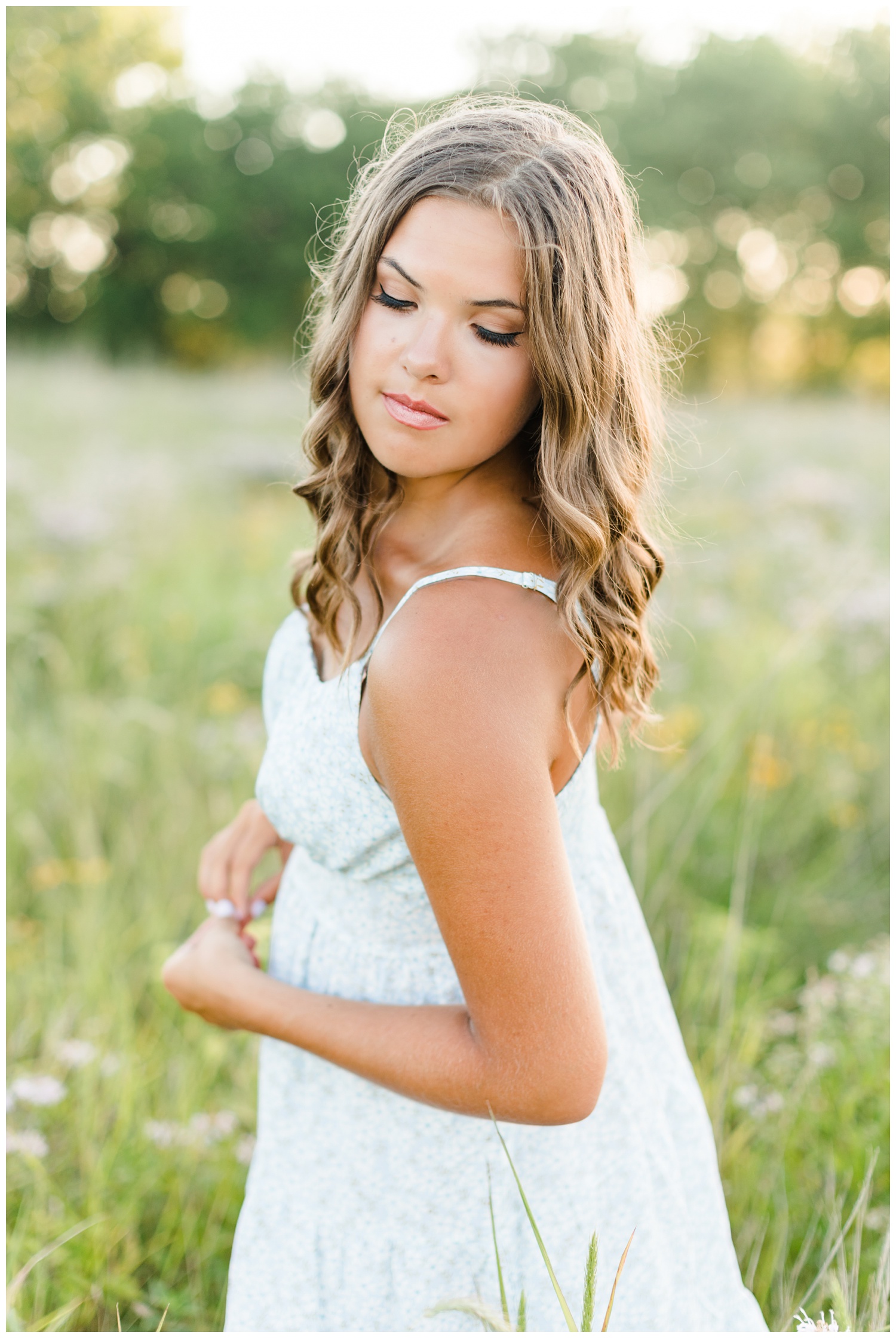 Analia gracefully looks over her shoulder in the middle of a wildflower field in Iowa | CB Studio