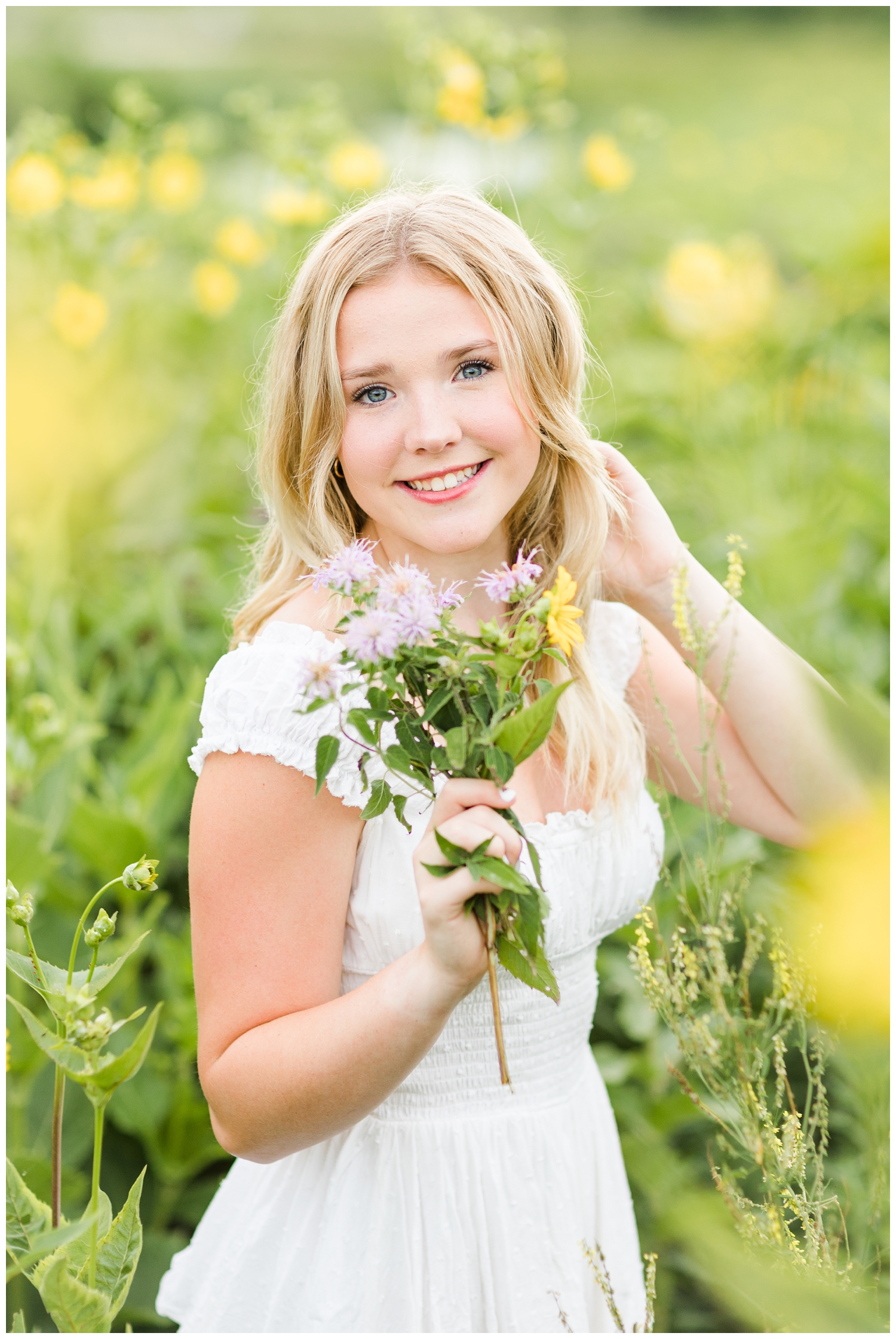 Cassie smiles while holding a bouquet of wildflowers | CB Studio