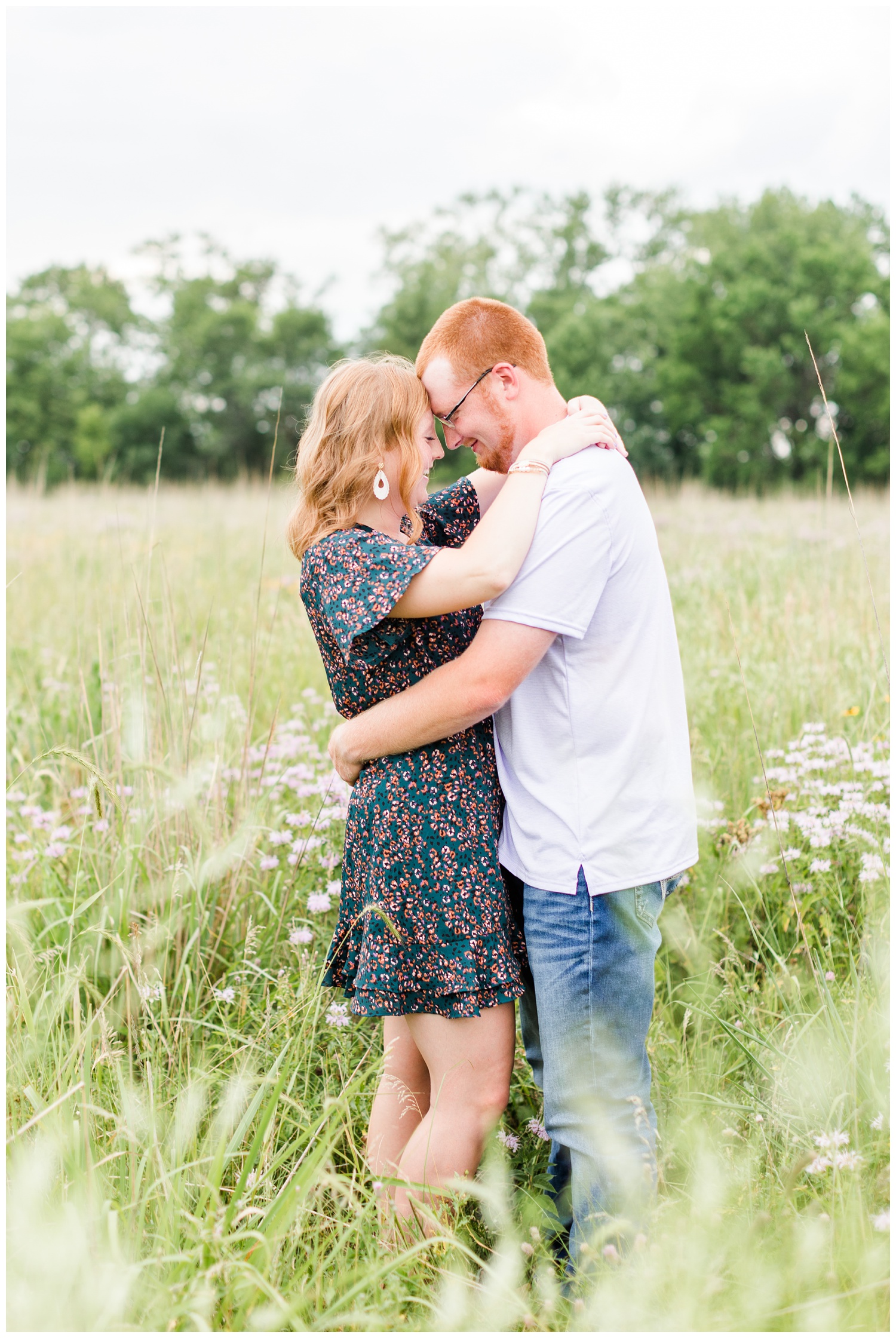 Leslie and Matt embrace each other in the middle of a wildflower field | CB Studio