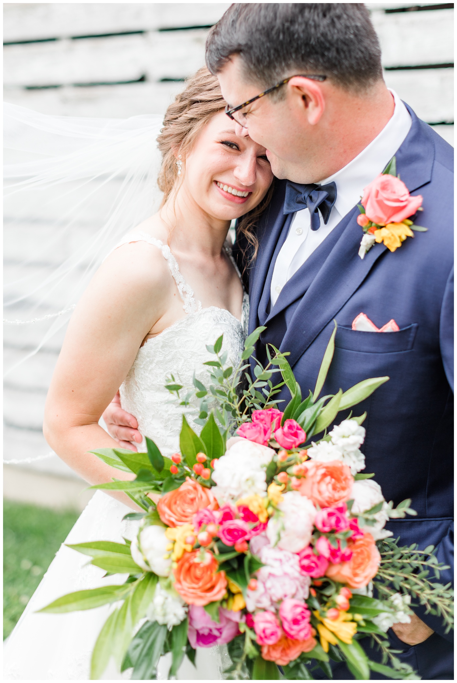 Leslie embraces her groom as they stroll through her grandparents farm | CB Studio