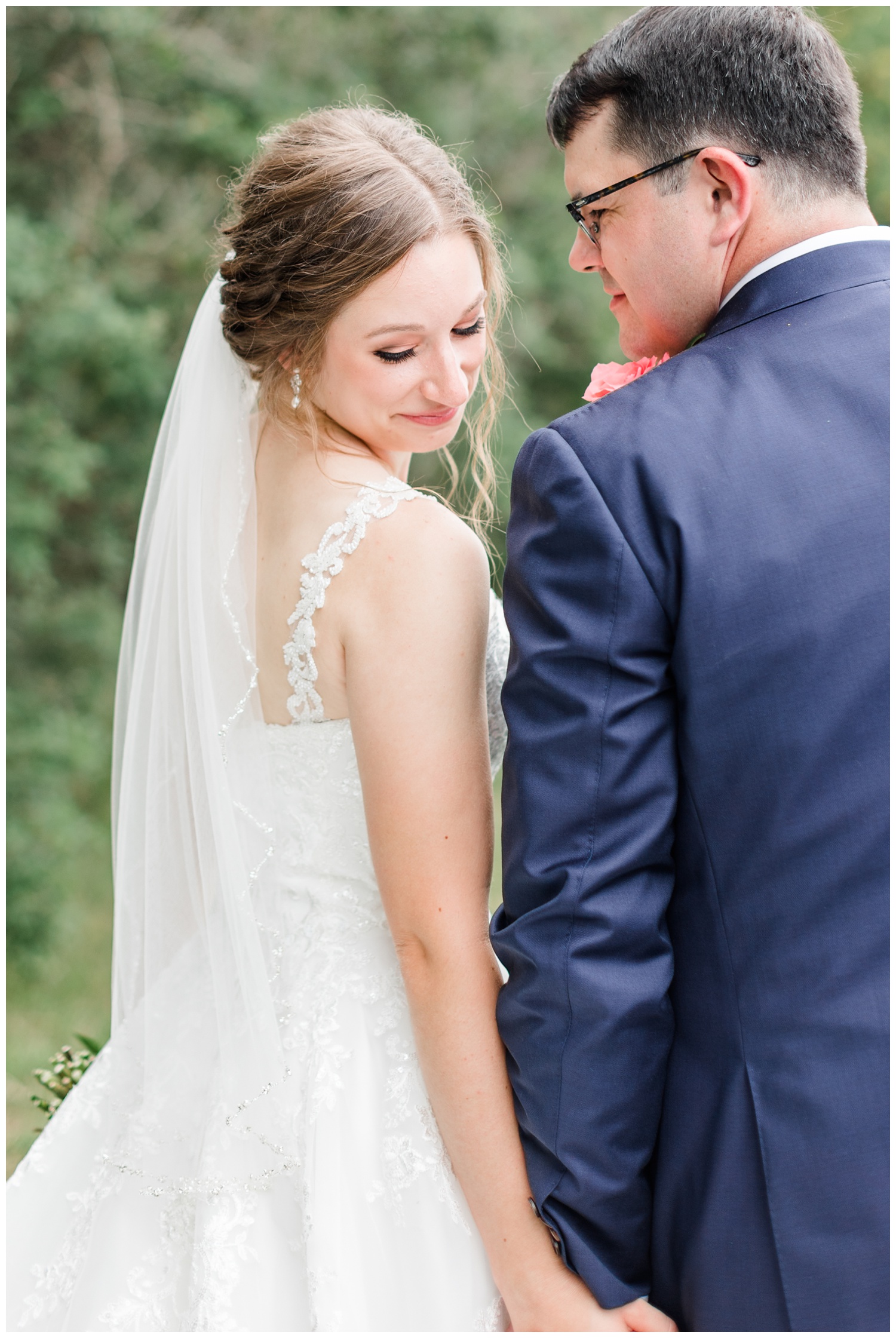 Joe looks down on his bride as they walk hand in hand on Leslie's grandparents farm | CB Studio