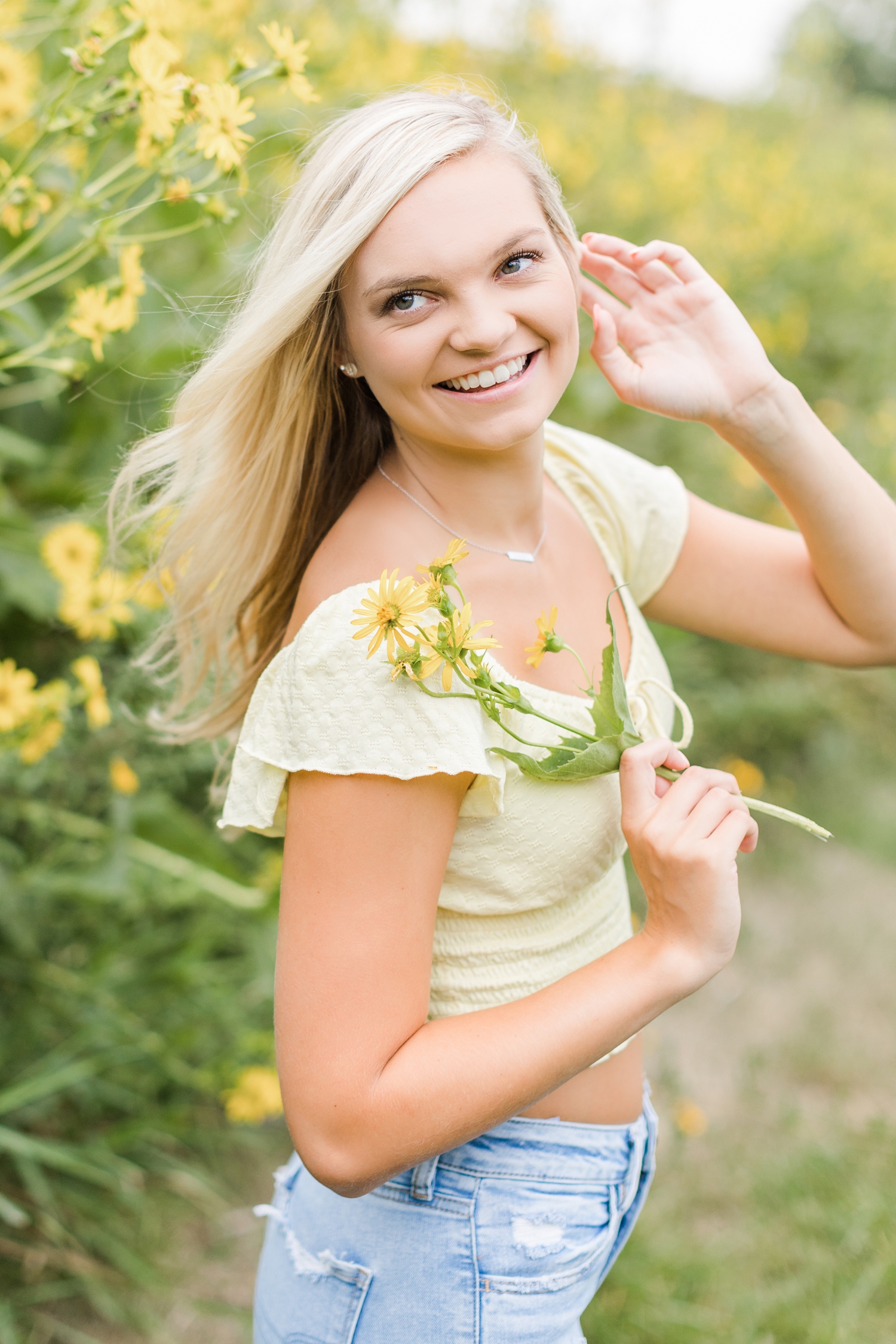 Jade laughs as the breeze blows through her hair in a yellow cup plant field | CB Studio