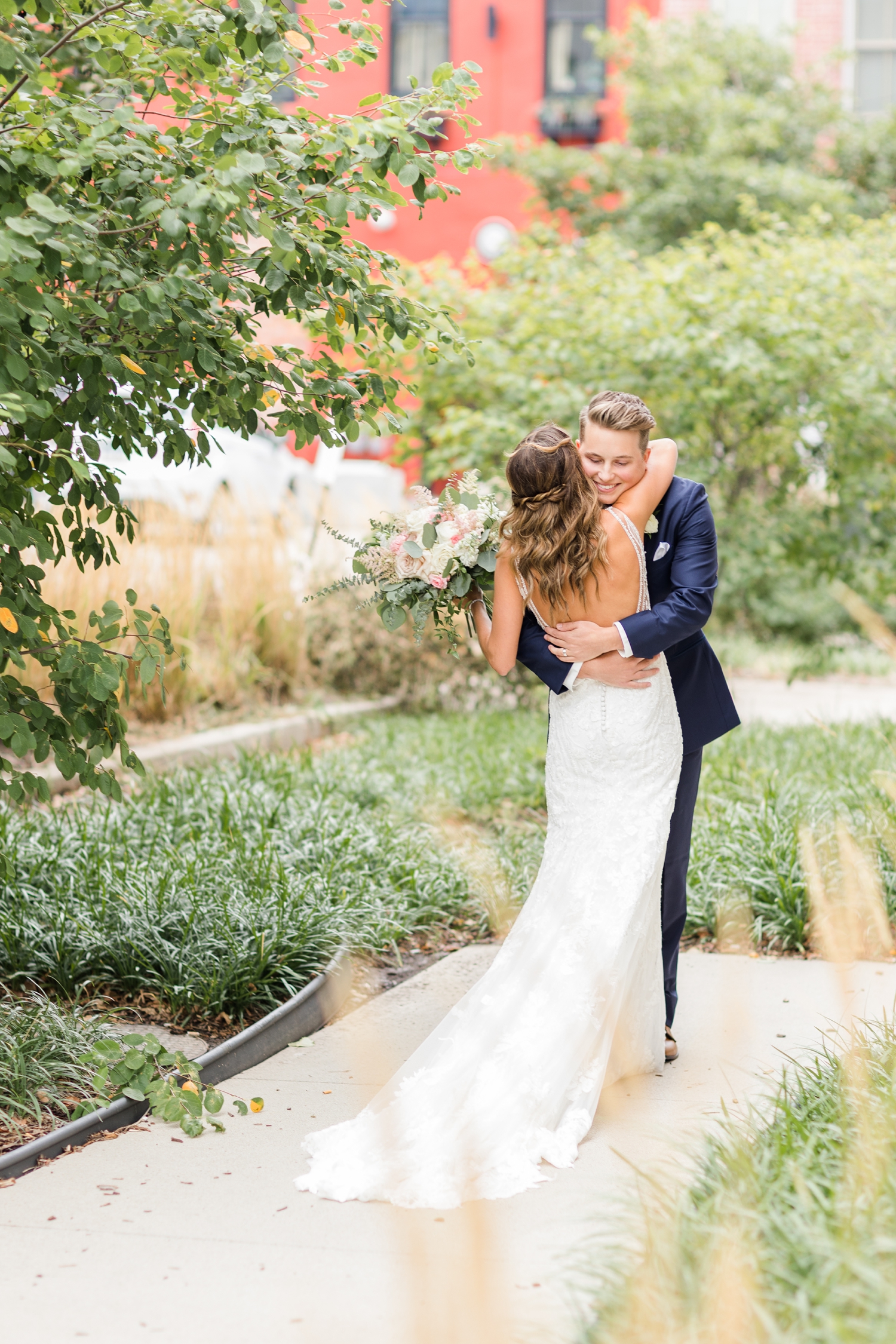 Jadi hugs her groom just outside the AC Hotel in Des Moines, seeing him for the first time on their wedding day | CB Studio