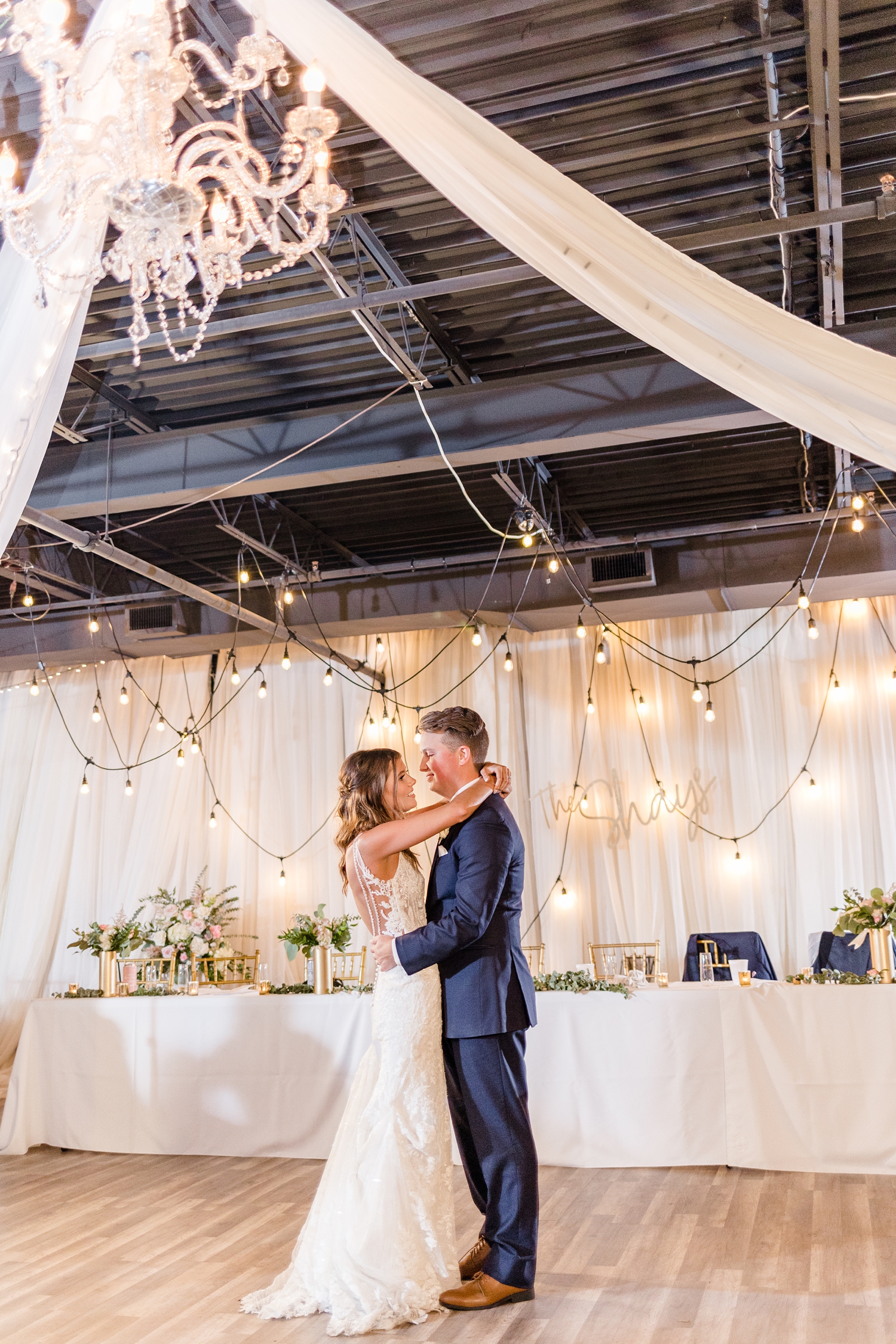 Jadi and Luke share their first dance under the crystal chandelier at The Conservatory in downtown Des Moines | CB Studio