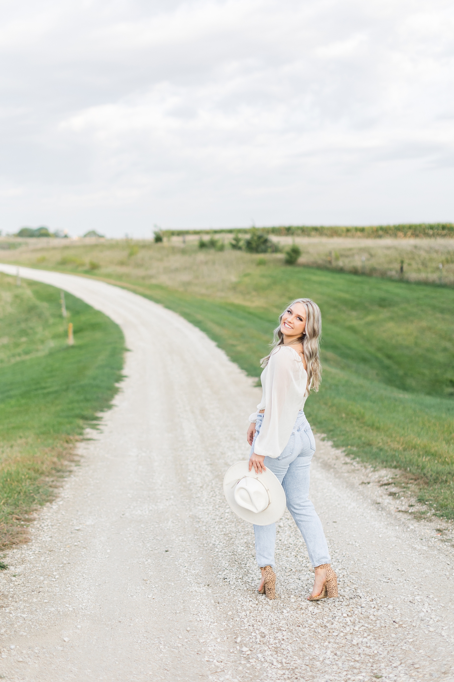 Shelby looks back and smiles while walking down a gravel road | CB Studio