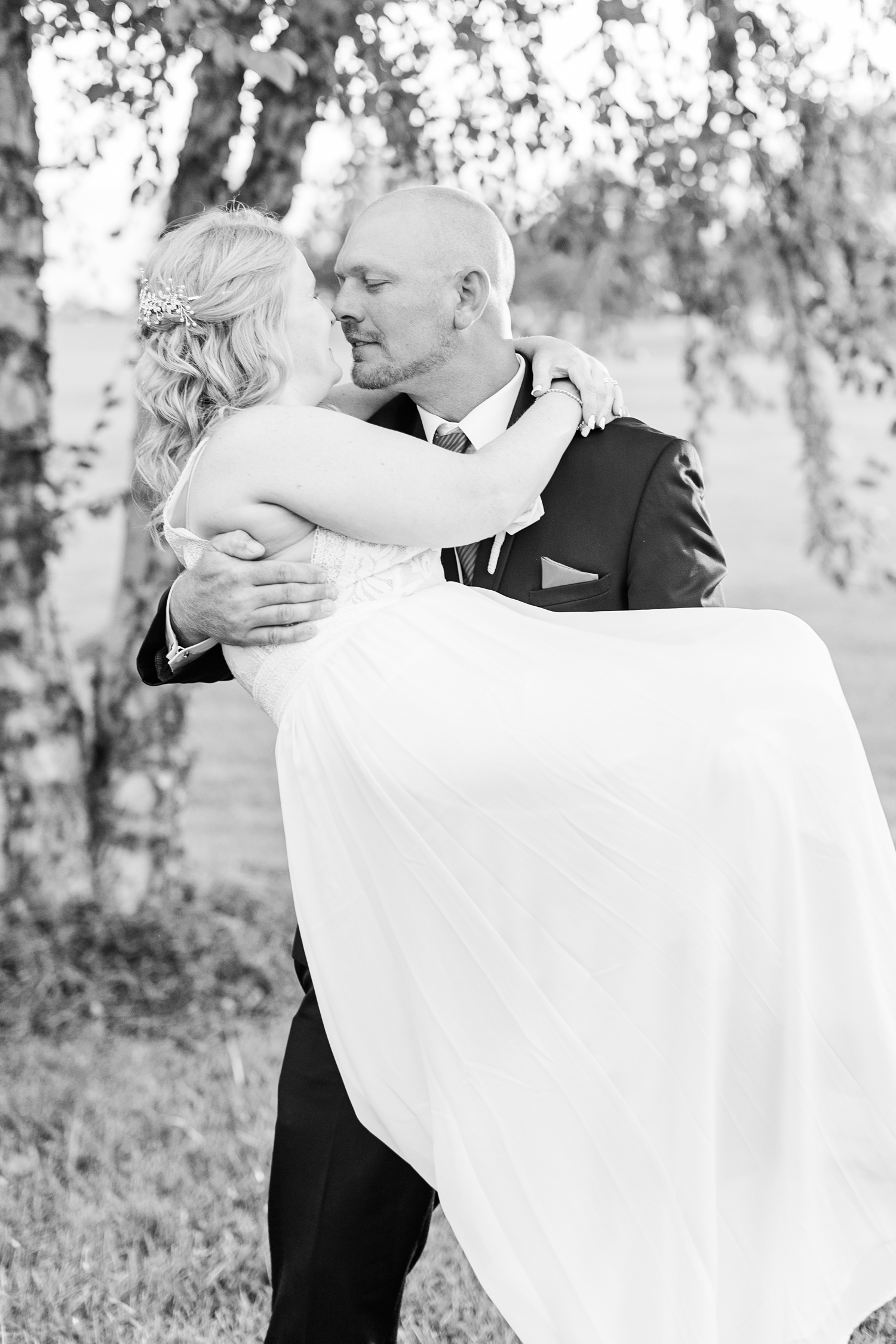 James carries his bride during sunset at the Opera House in Fort Dodge | CB Studio