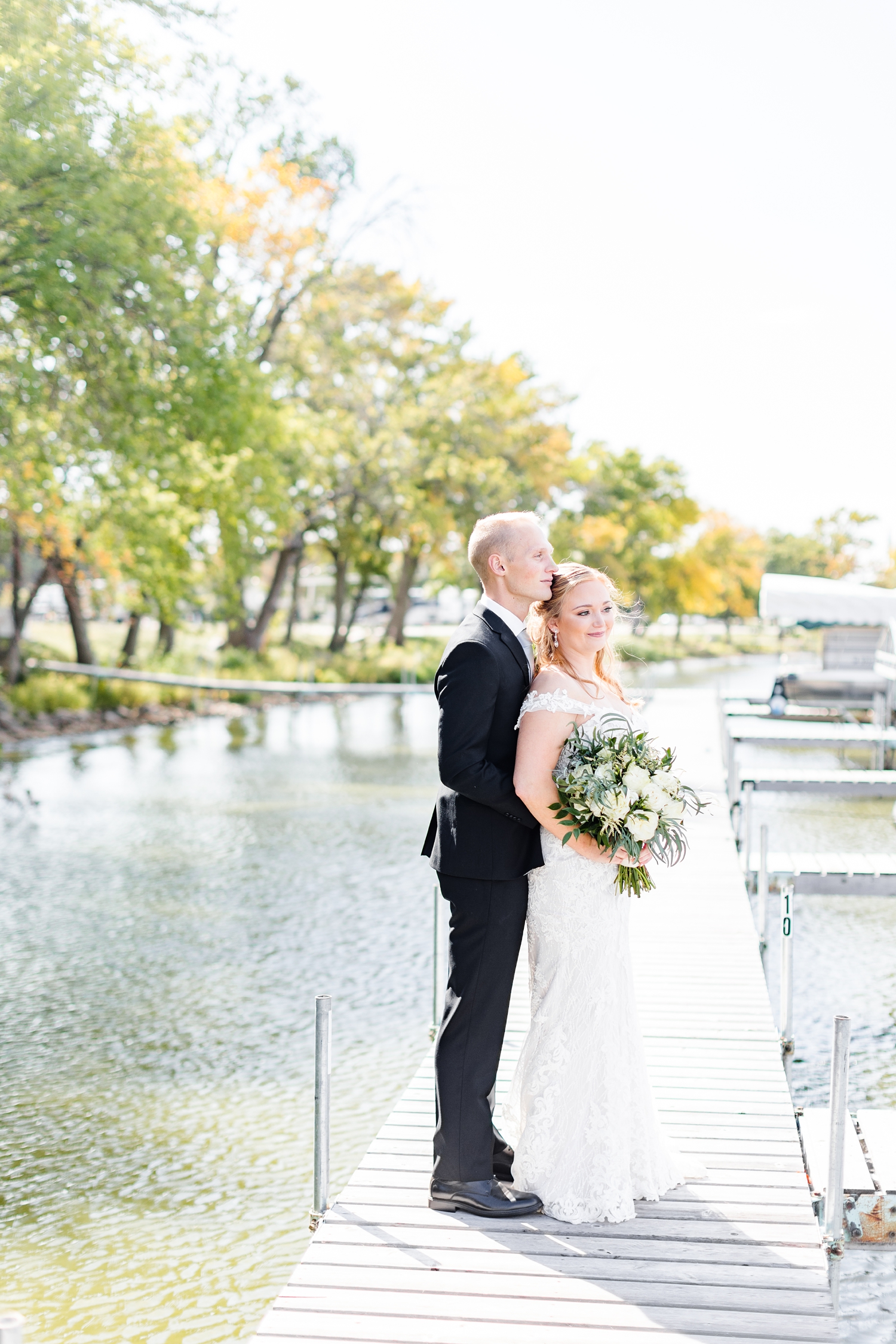 Jacob and Brenna stand on a dock looking out to Five Island Lake, Emmetsburg, Iowa | CB Studio