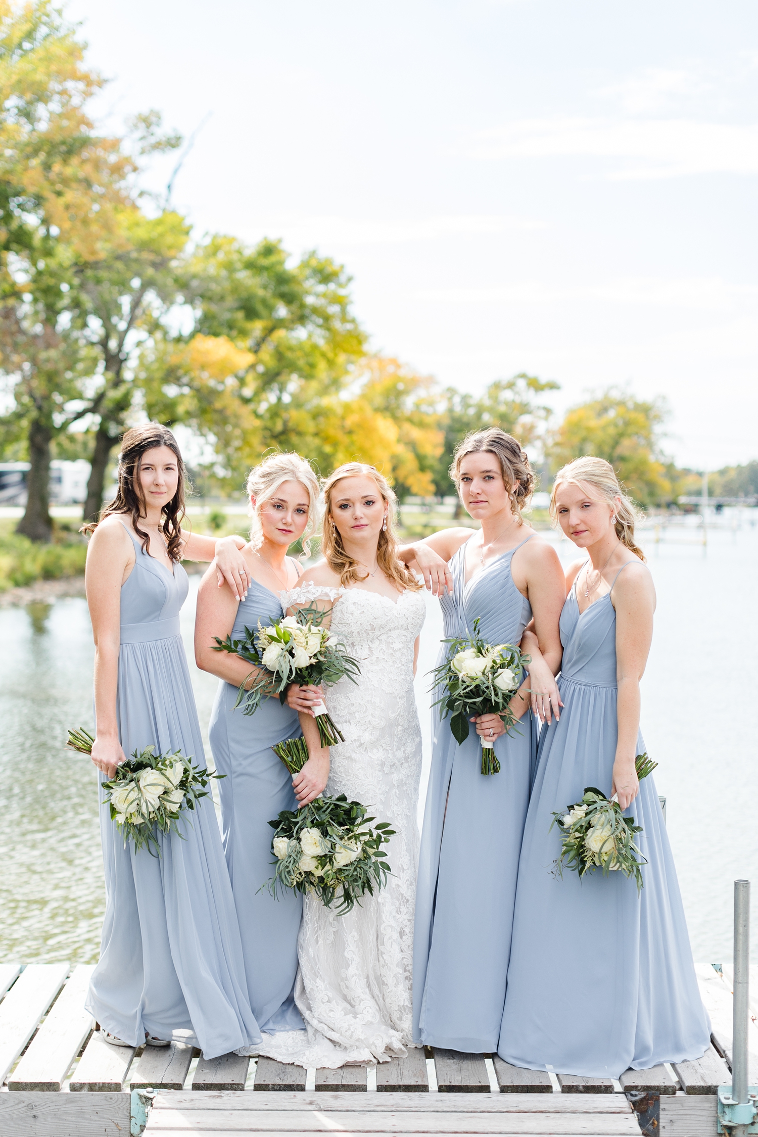 Brenna and her bridesmaids stand on a dock at Five Island Lake, Emmetsburg, Iowa | CB Studio