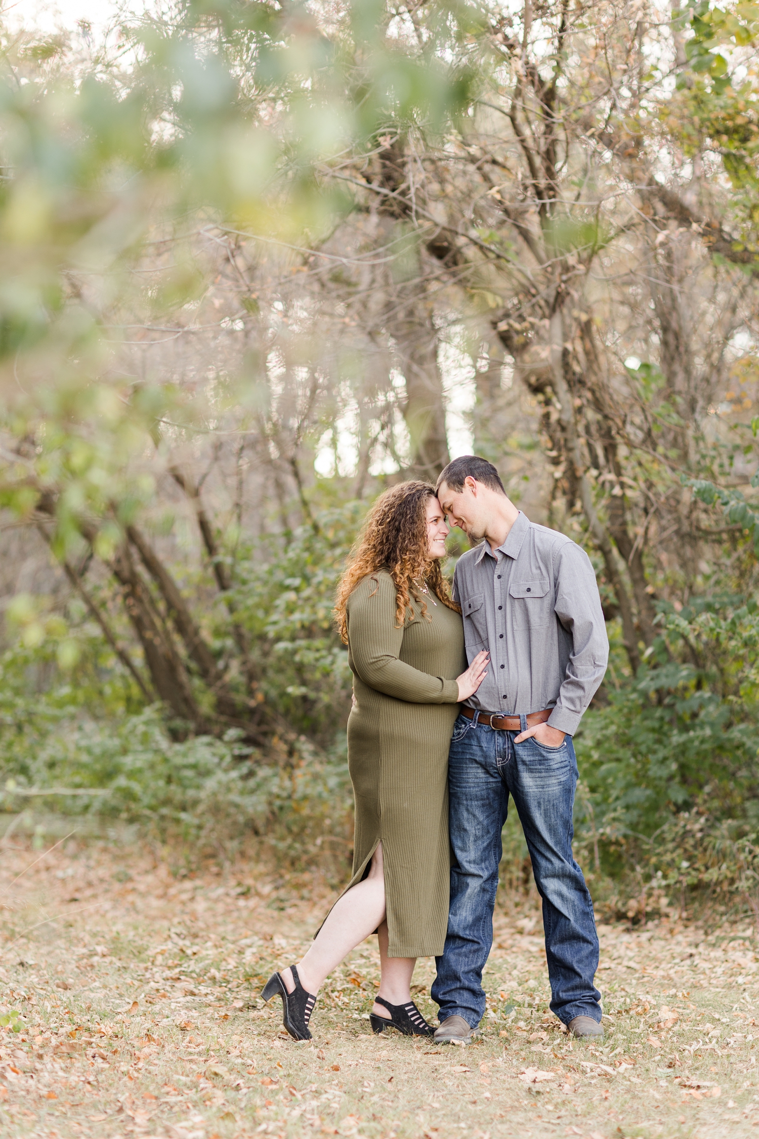 Holly and Dakota embrace under a path of trees | CB Studio