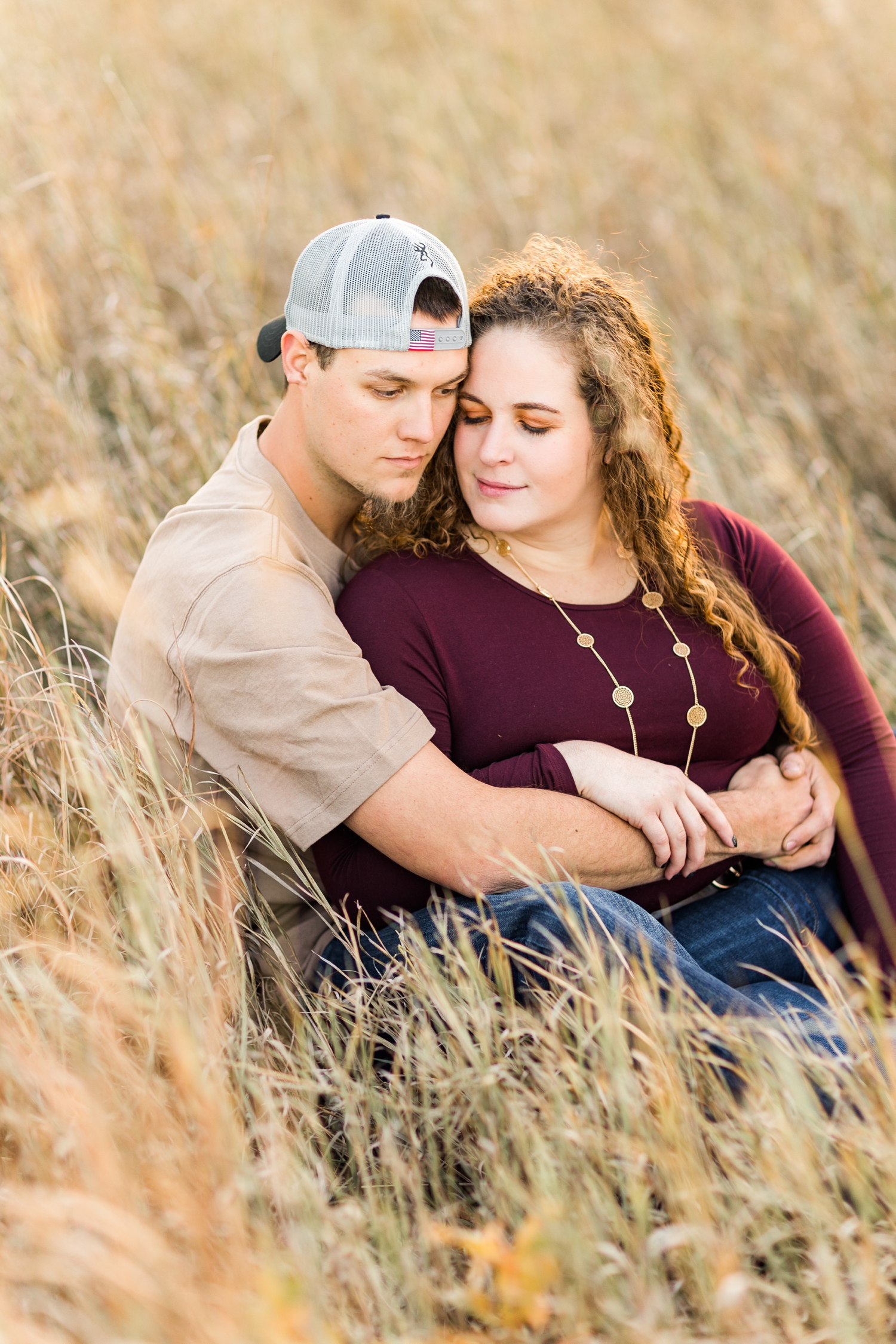 Dakota embraces Holly as they sit nestled in Iowa fall prairie grass | CB Studio