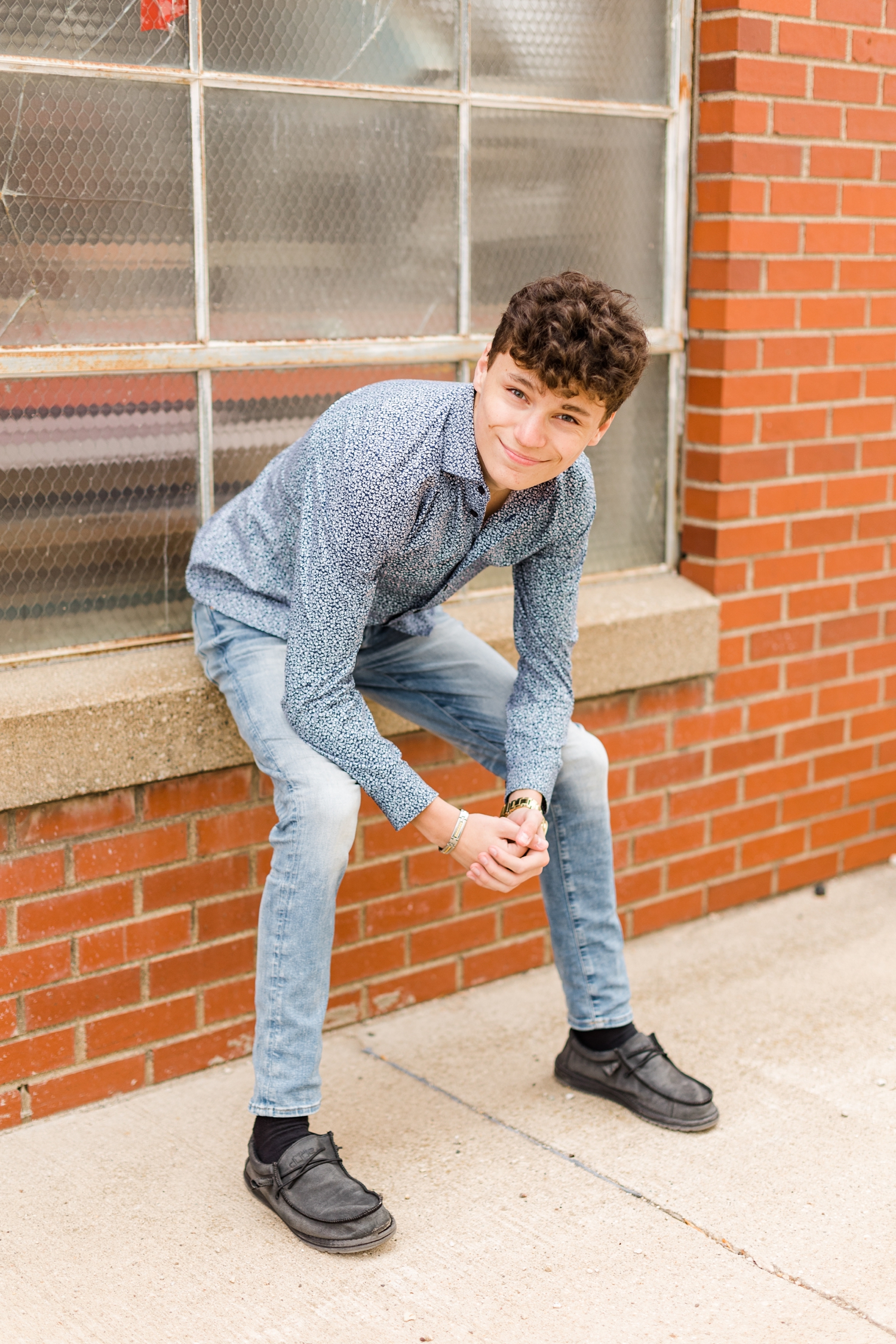 Joey sits in a window sill of an old factory building in downtown Algona, Iowa | CB Studio