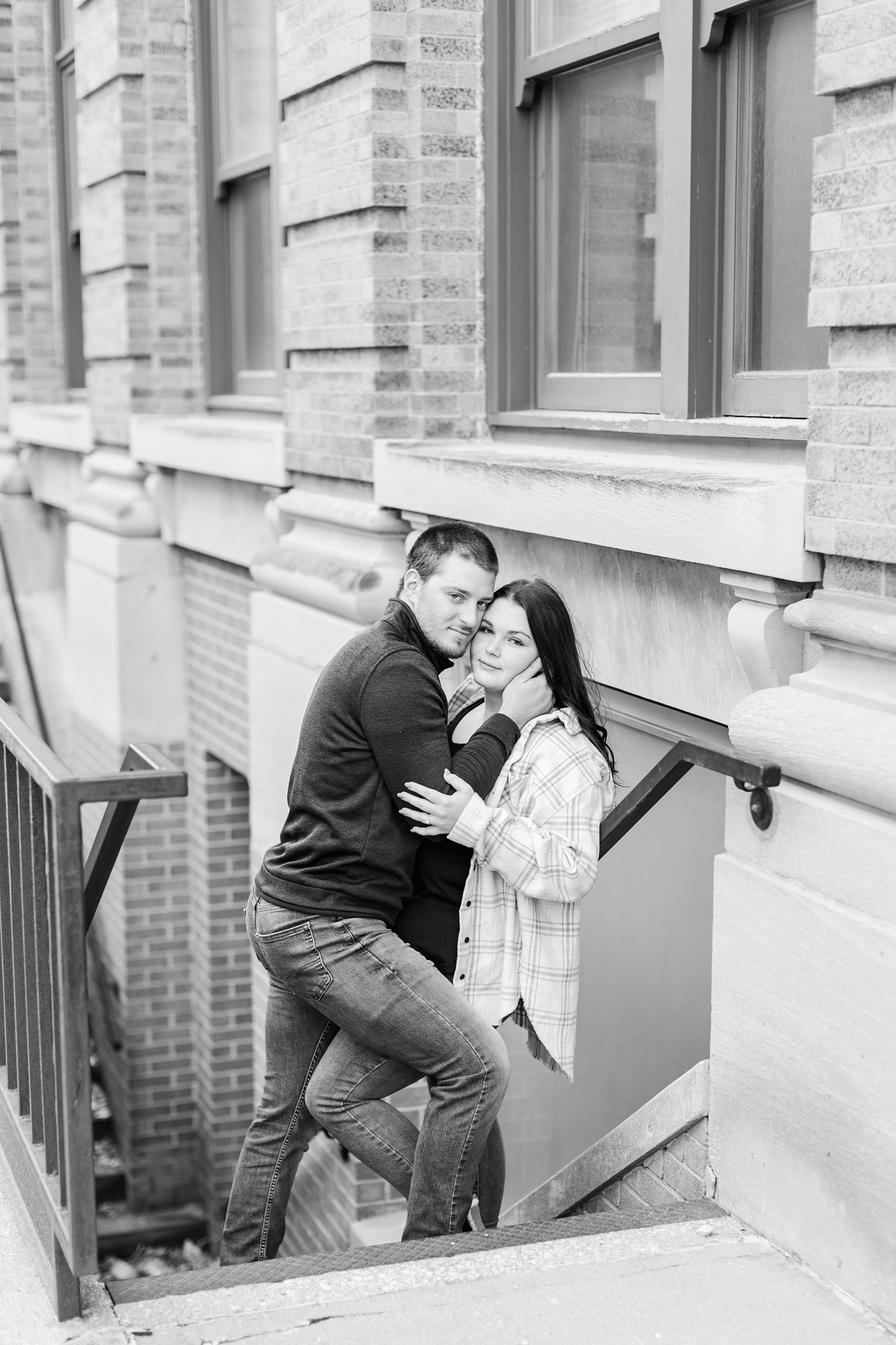 Mary and Austin embrace in a stairwell of a historic building in downtown Fort Dodge, IA | CB Studio