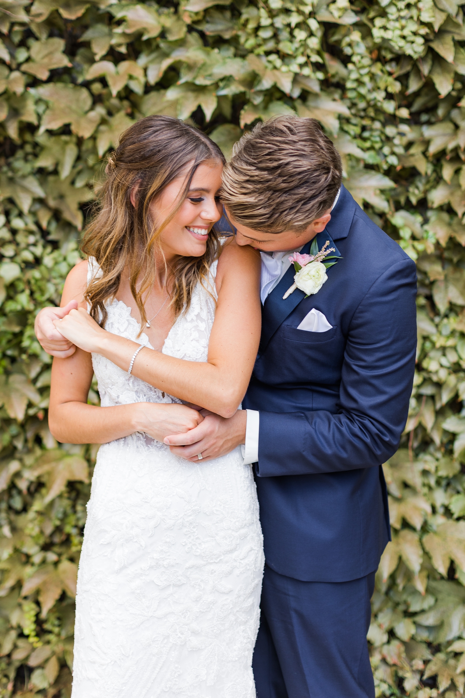 Luke kisses his new bride's shoulder softly in downtown Des Moines | CB Studio