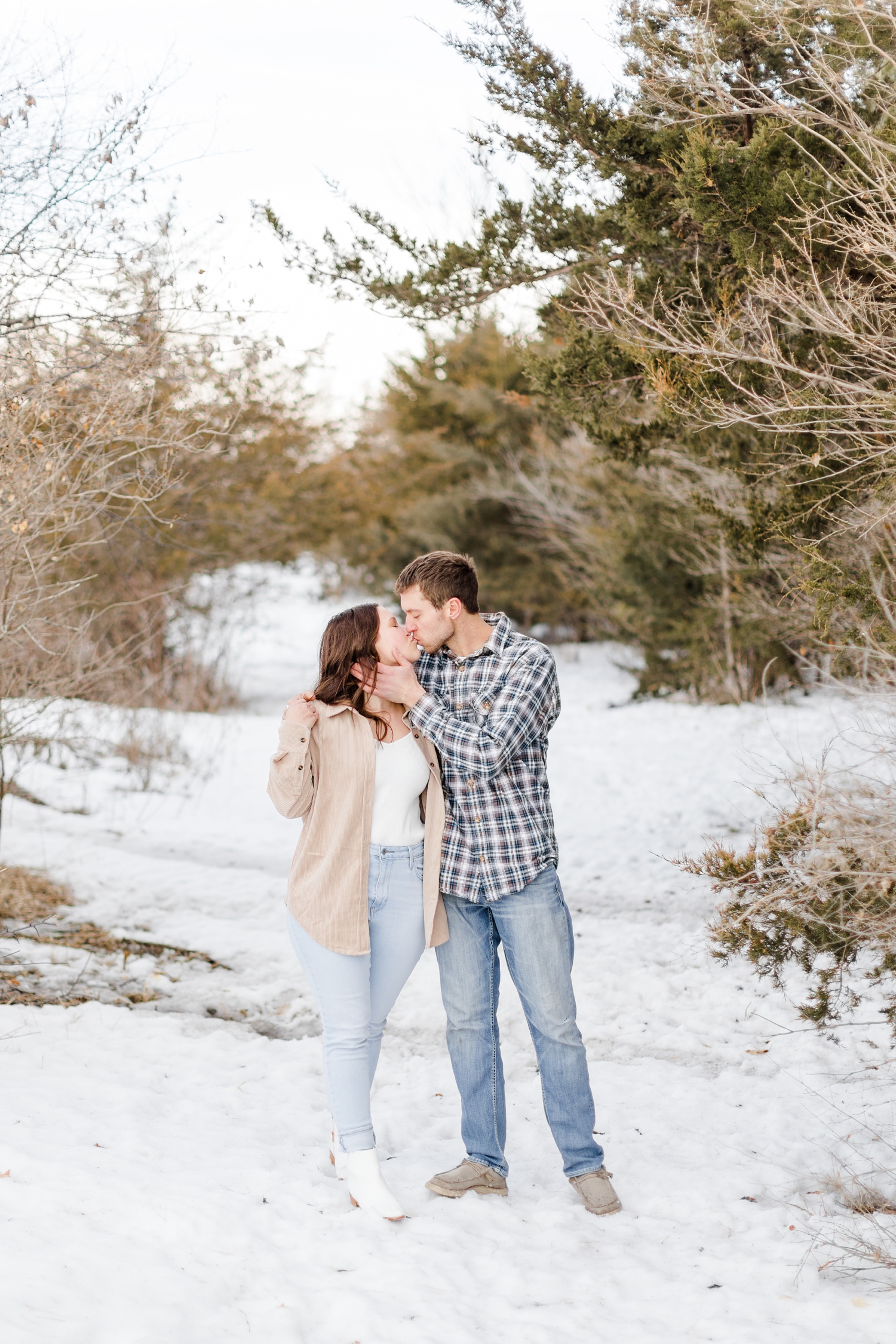 Grant gently pulls his bride to be, Alyssa, in for a kiss at Water's Edge Nature Center | Iowa Wedding Photographer | CB Studio