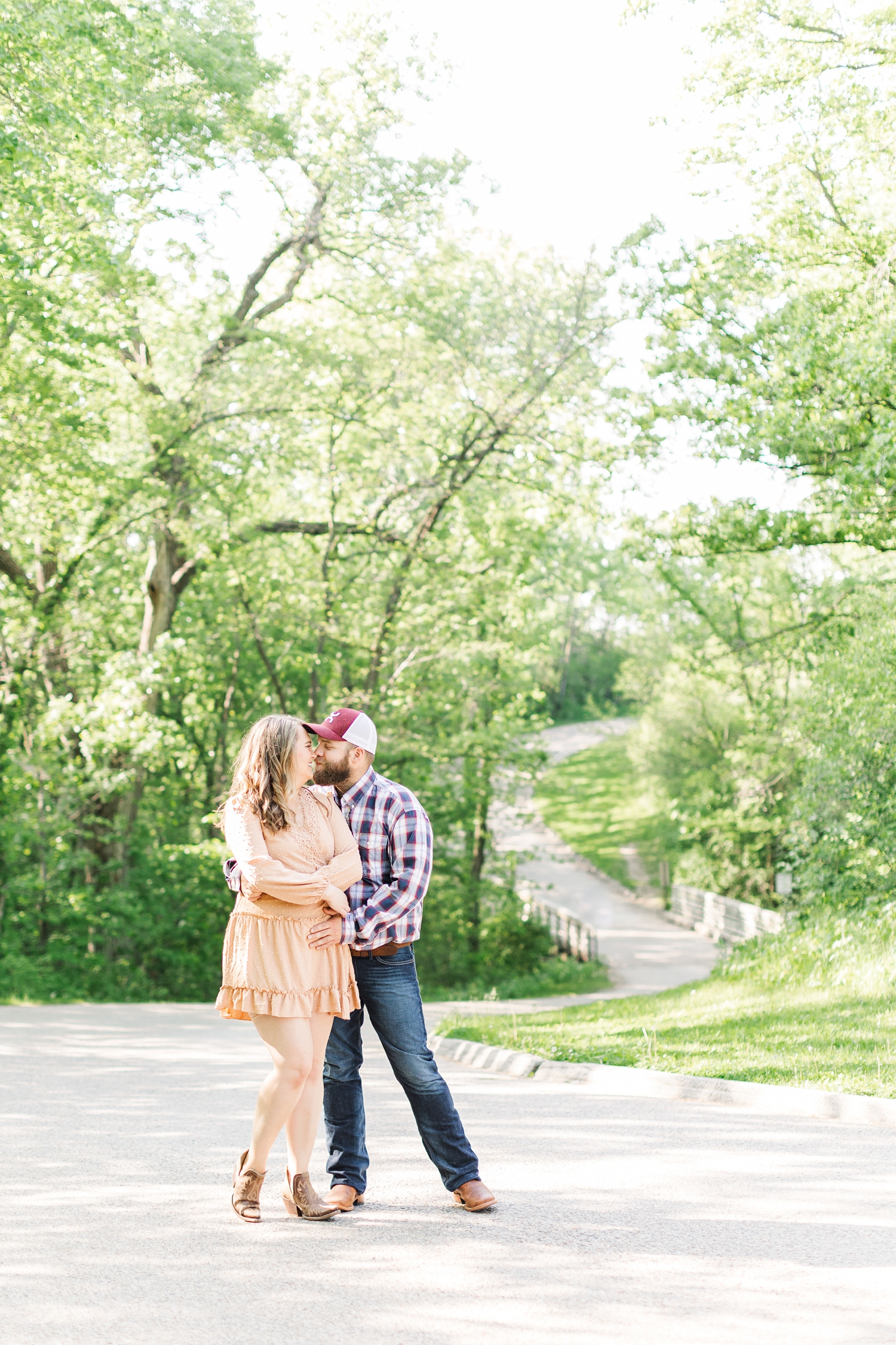 Megan and Matt hold each other close in the middle of the road at Jester Park in Granger Iowa | CB Studio