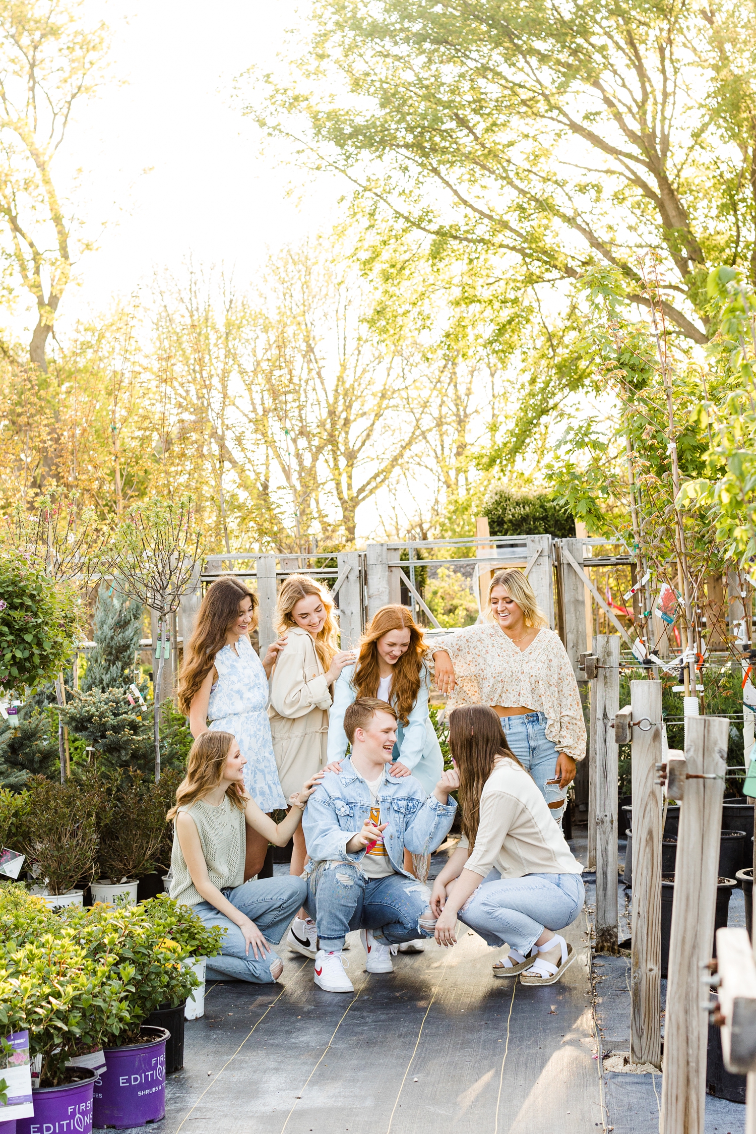 Senior spokesmodel class of 2024 laughing together at the tree and shrub area of a greenhouse| CB Studio