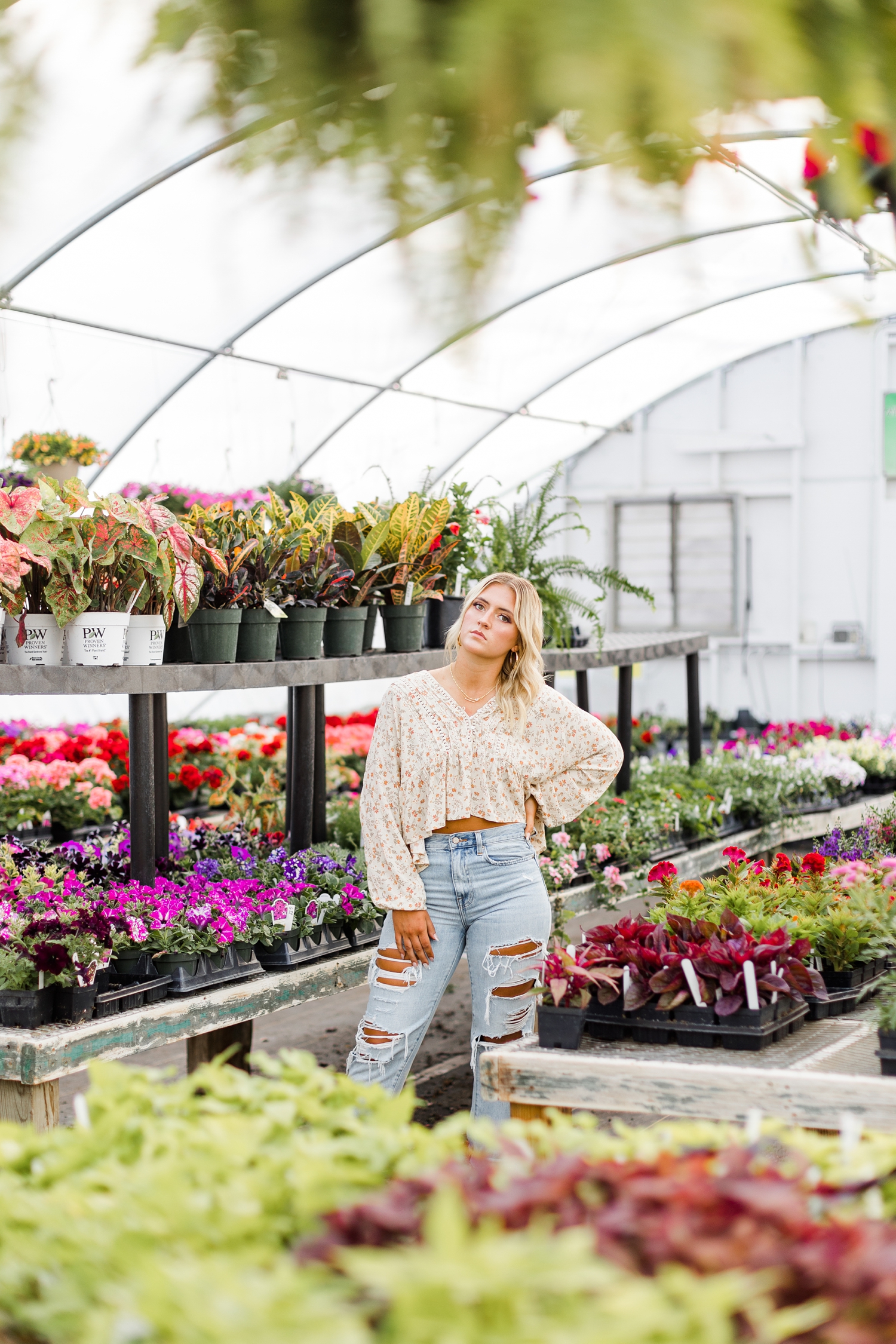 Senior spokesmodel Jenna poses inside a greenhouse full of luscious plants | CB Studio