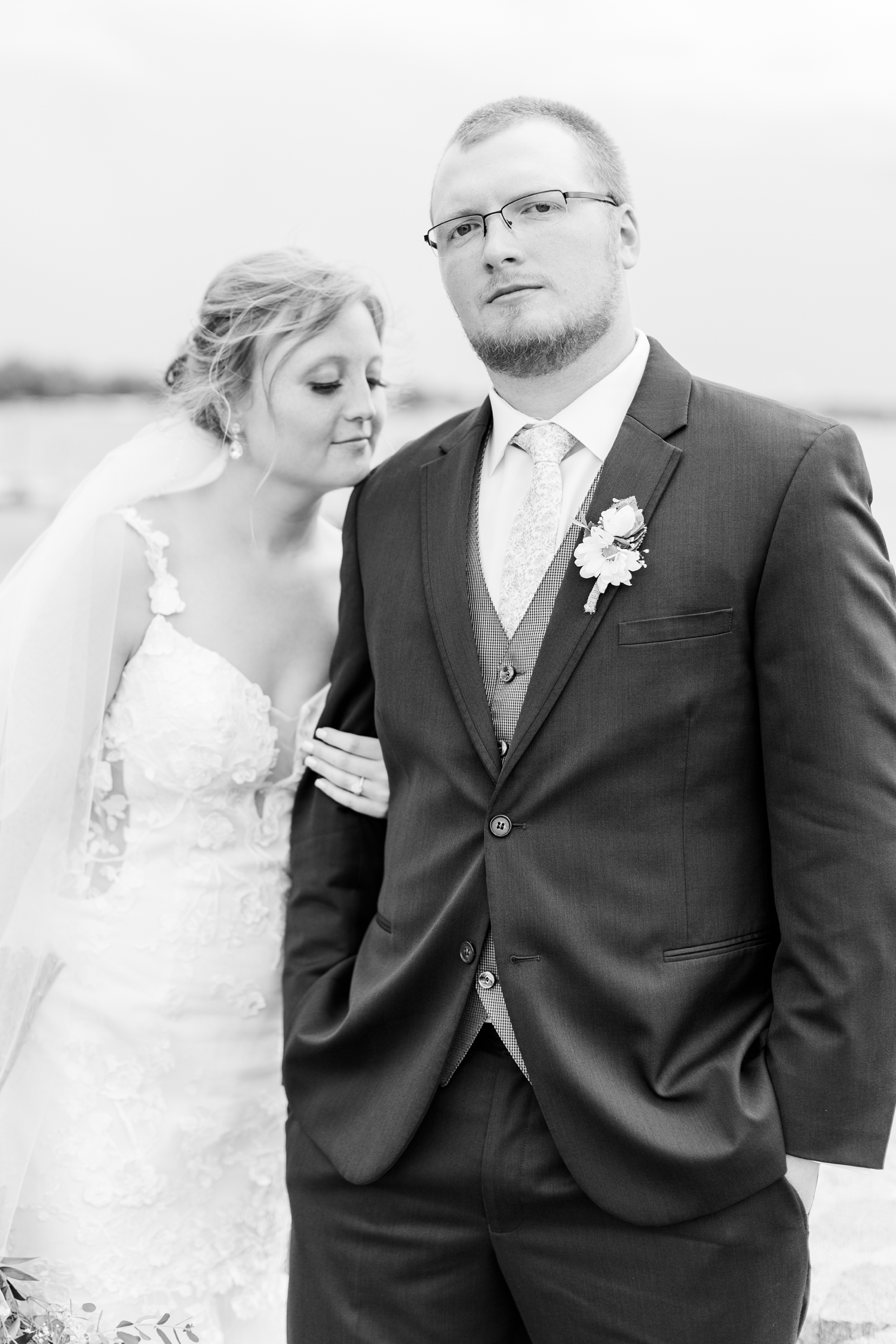 Lauryn rests her chin on her new husband's shoulder by Clear Lake, Iowa | CB Studio