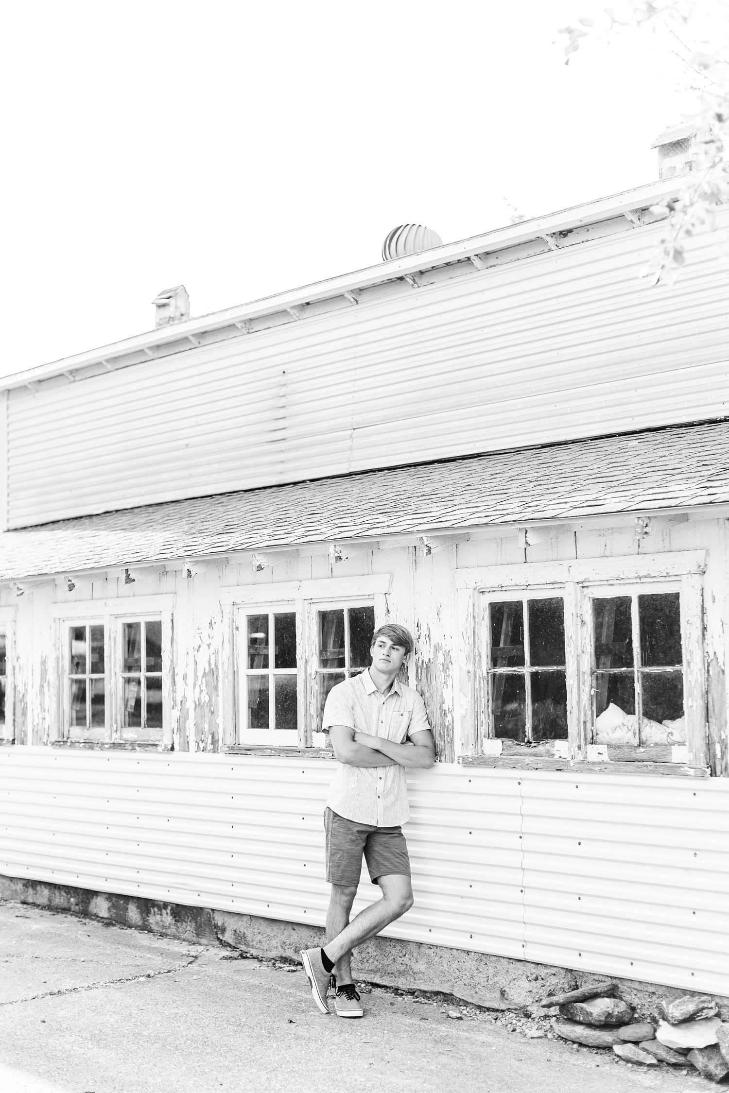 Aidan leans against an old wooden chicken coop on his family farm | CB Studio
