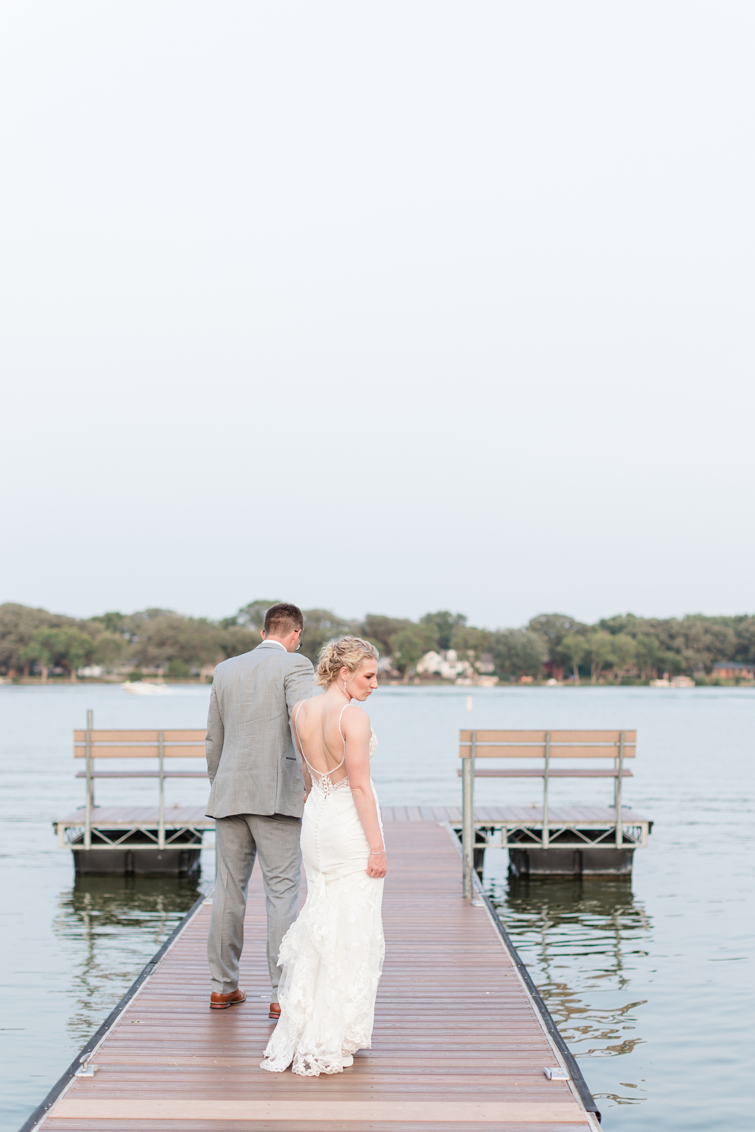 Quinton leads his bride out on the dock at sunset at the Shores at Five Island | CB Studio