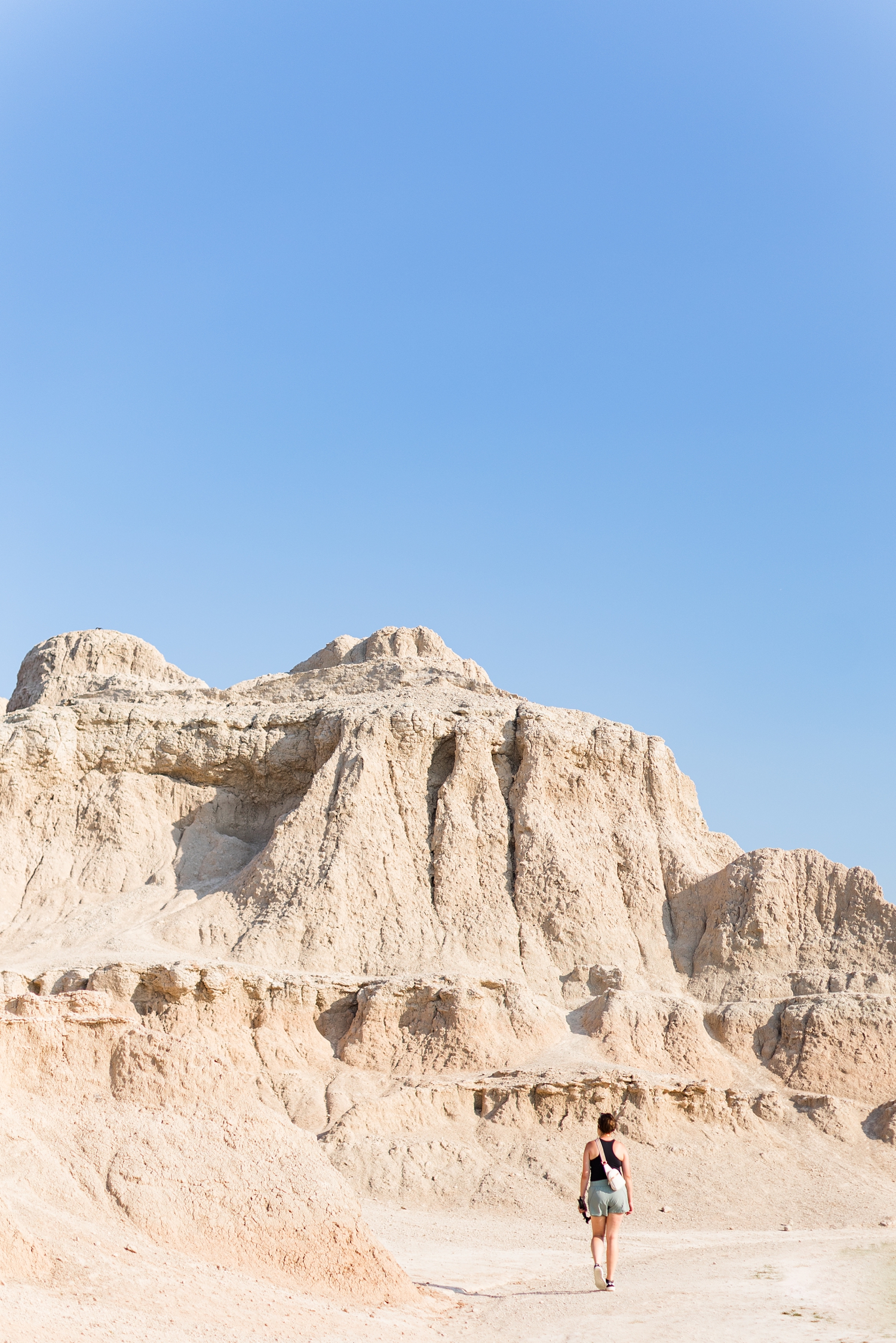 Brandee walks towards a large formation in the Badlands National Park | CB Studio