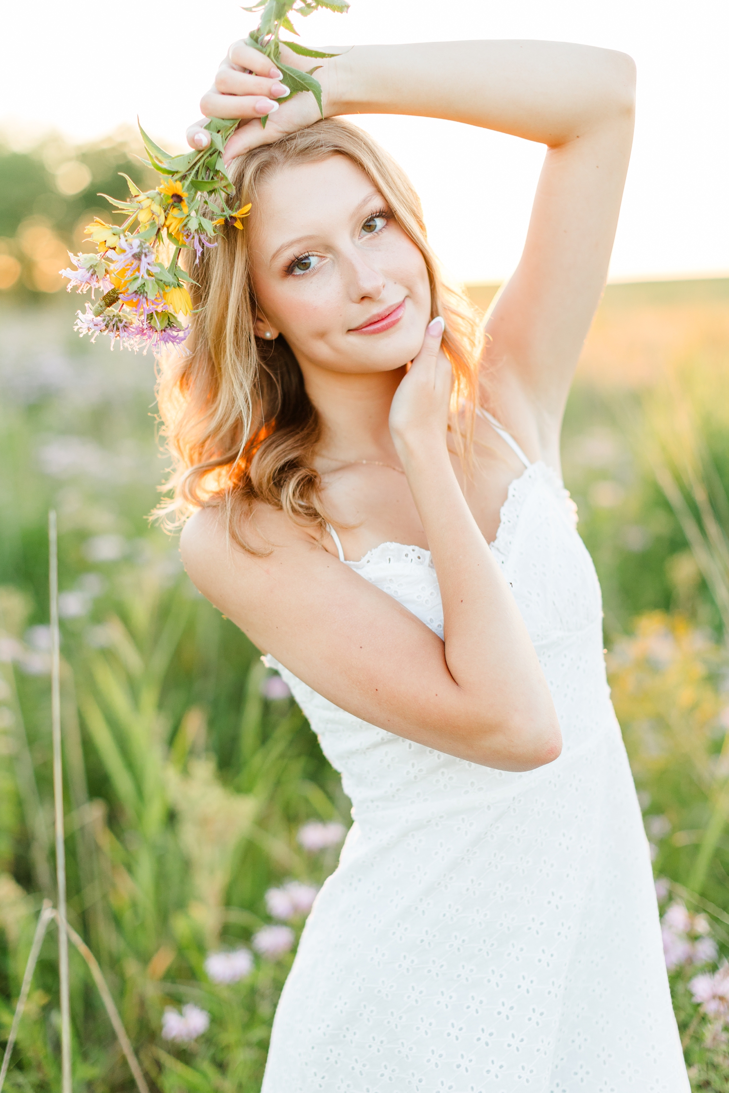 Ryley frames her face with flowers from a wildflower field at sunset | CB Studio