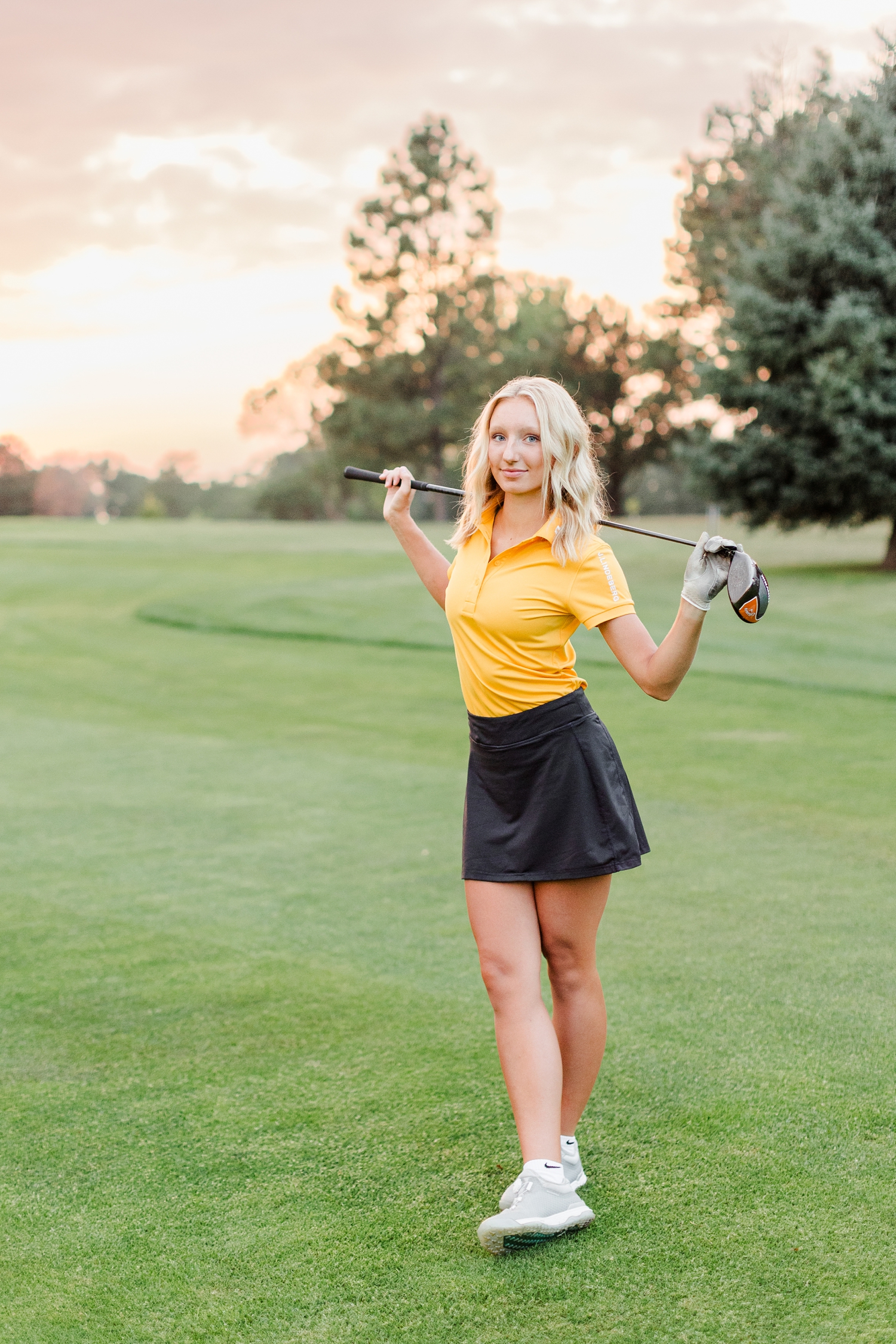 Avery poses with her driver across the back of her shoulders at Spring Valley Golf Course at sunset | CB Studio