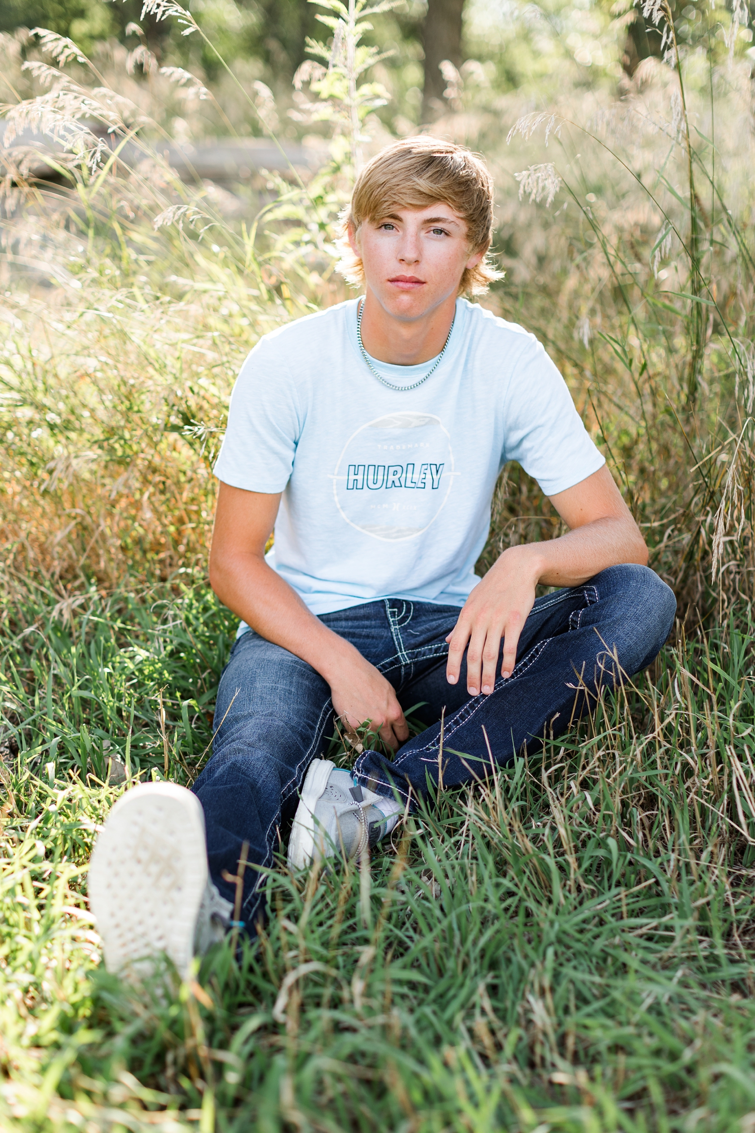 Justin sits in the middle of a grassy field | CB Studio