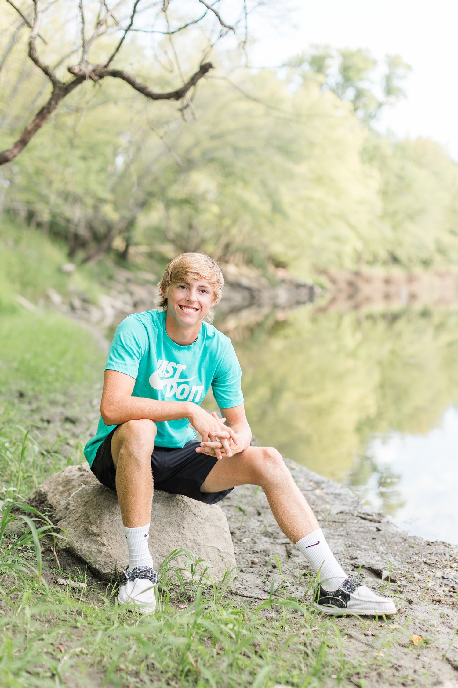 Justin sits on the banks of the East Fork Des Moines River | CB Studio