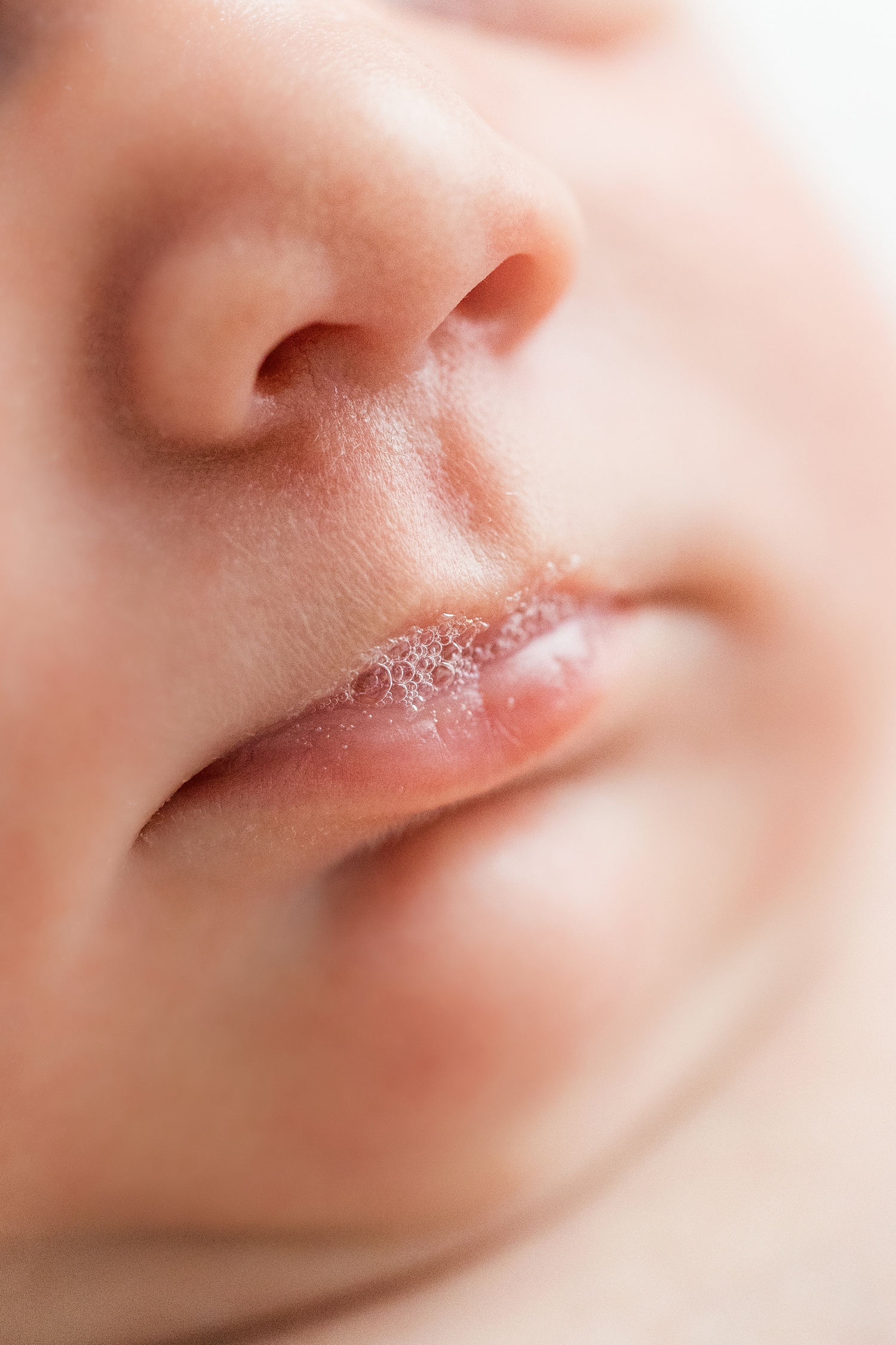 Close up detail image of baby Elizabeth's tiny lips and with bubbles spilling out | CB Studio