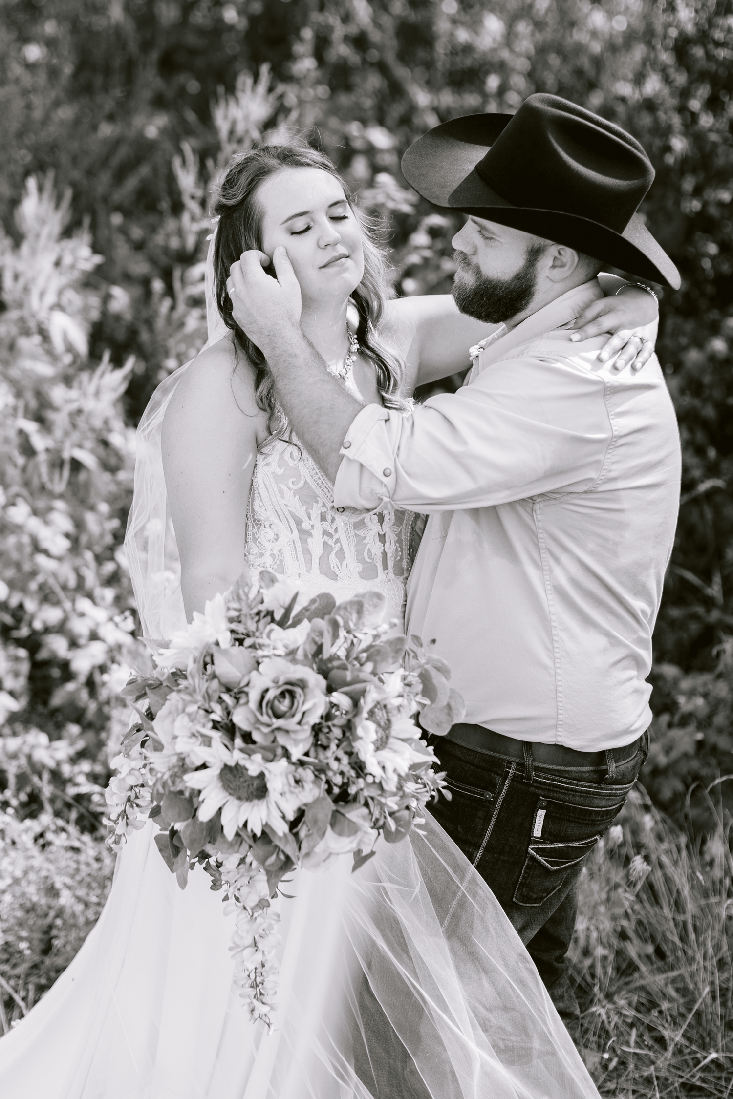 Matt gently brushes a stray hair off of his bride's, Megan, cheek | A rustic, country wedding with western touches | CB Studio