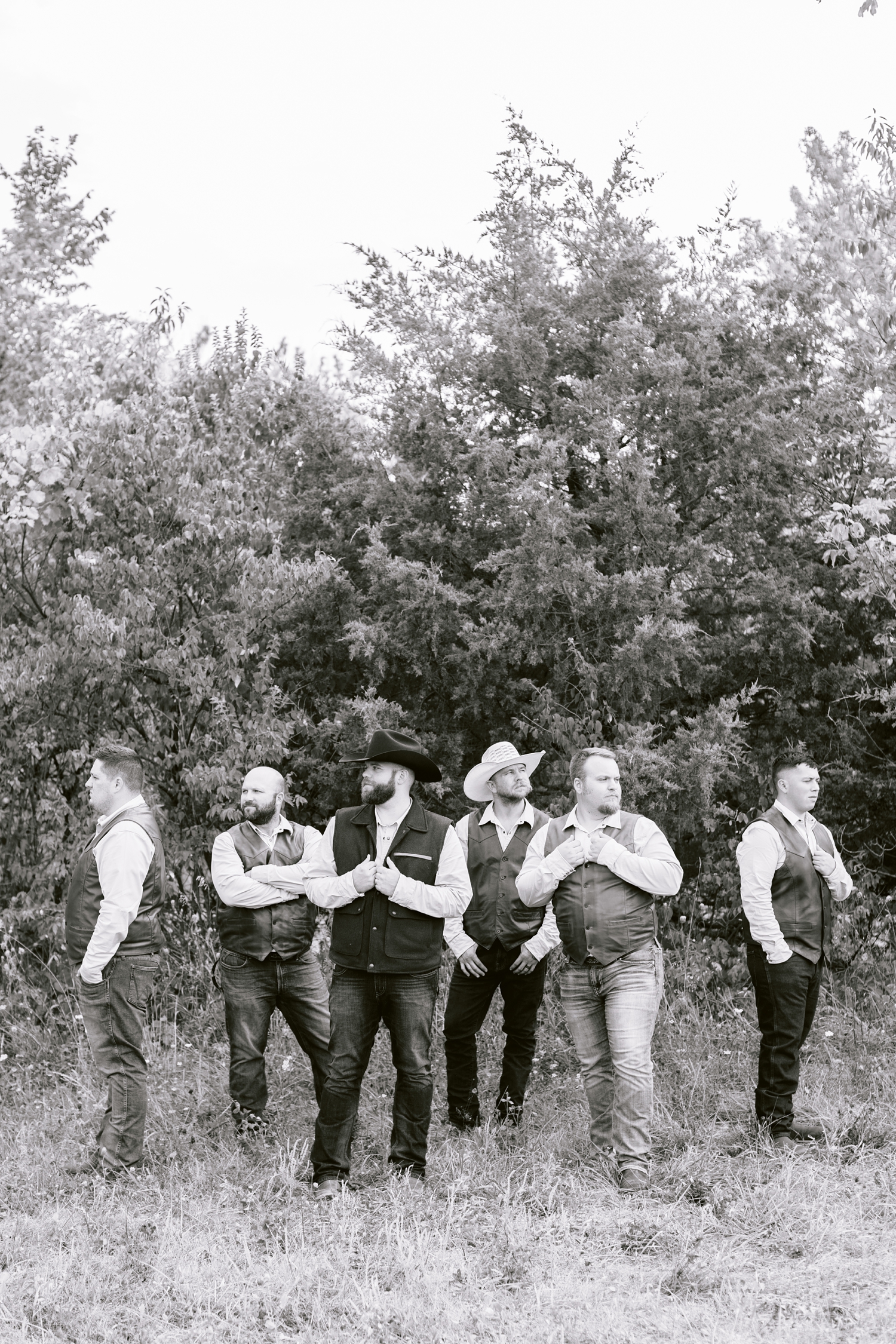 Matt and his groomsmen, wearing leather and wool vests and cowboy hats, pose dapperly | A rustic, country wedding with western touches | CB Studio