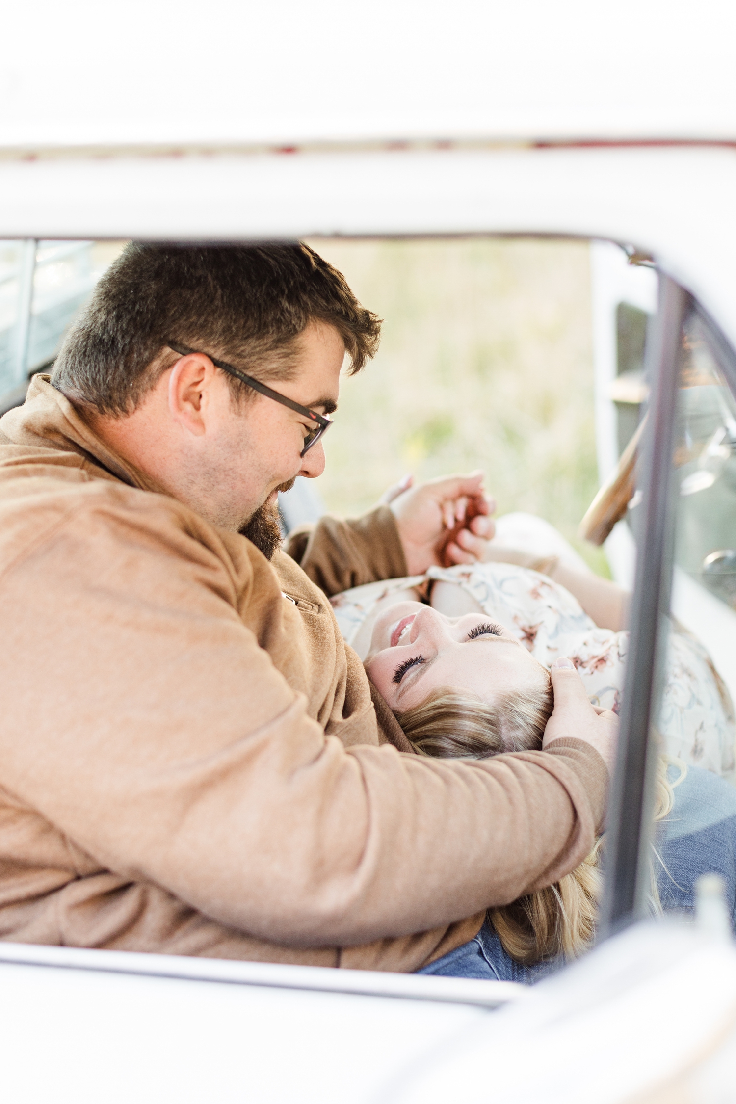 Halie lays her head on Nick's lap as they cuddle together in the cab of a 70's Ford truck | CB Studio