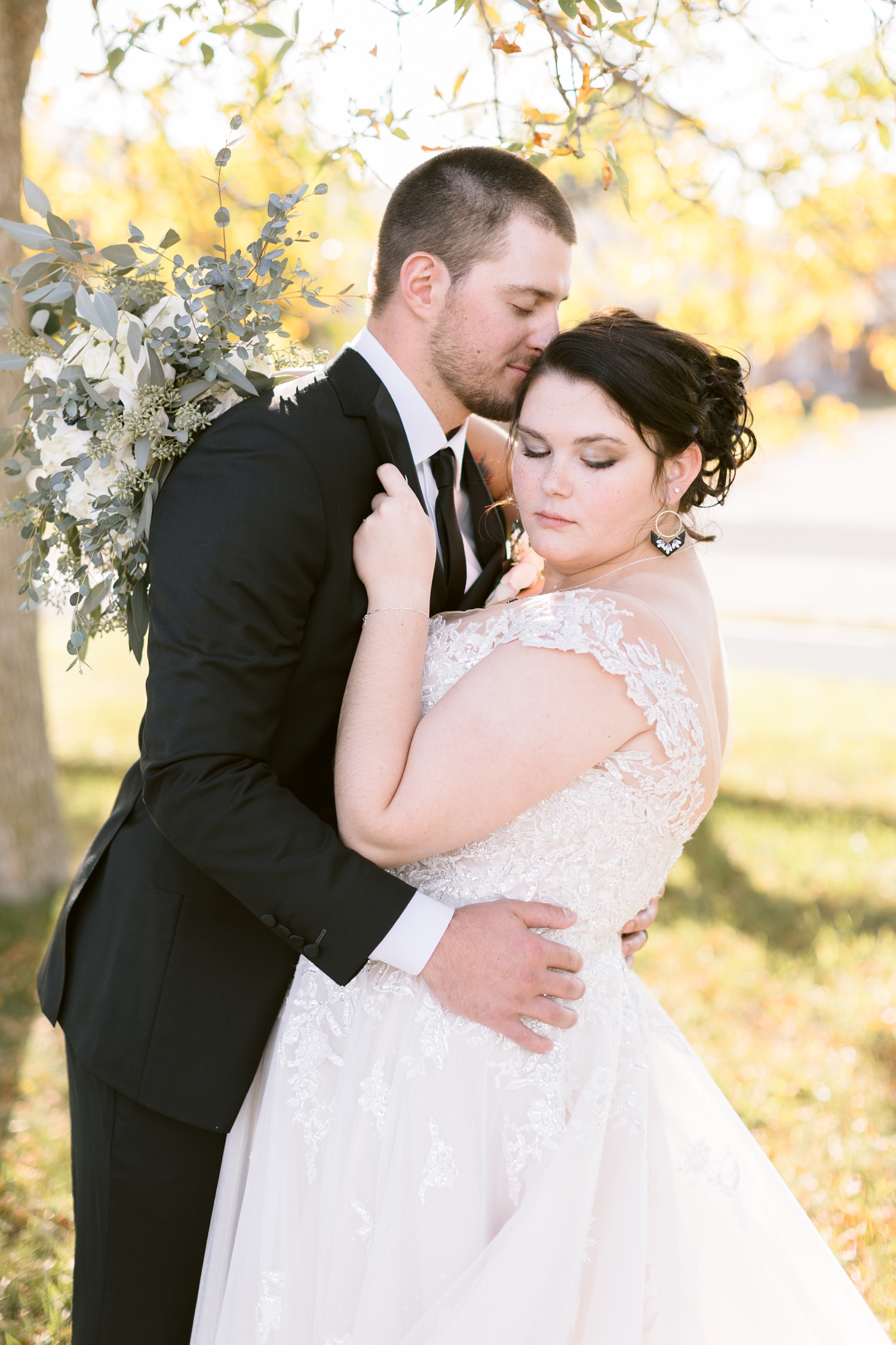 Austin gently nuzzles his new bride, Mary, as she looks down over her shoulder | CB Studio