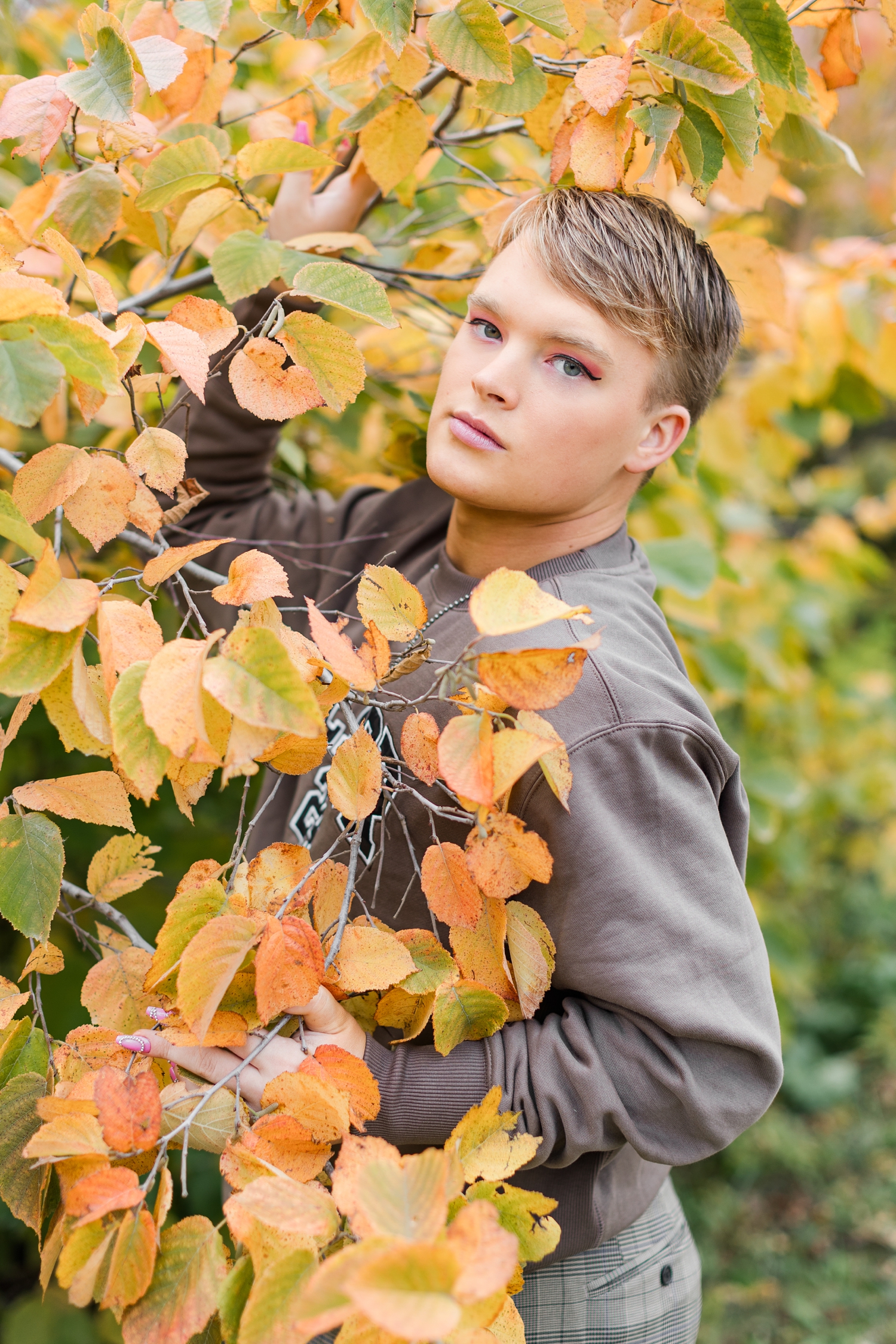 Seth is surrounded by orange and yellow fall leaves at Bode's Moonlight Farm | CB Studio