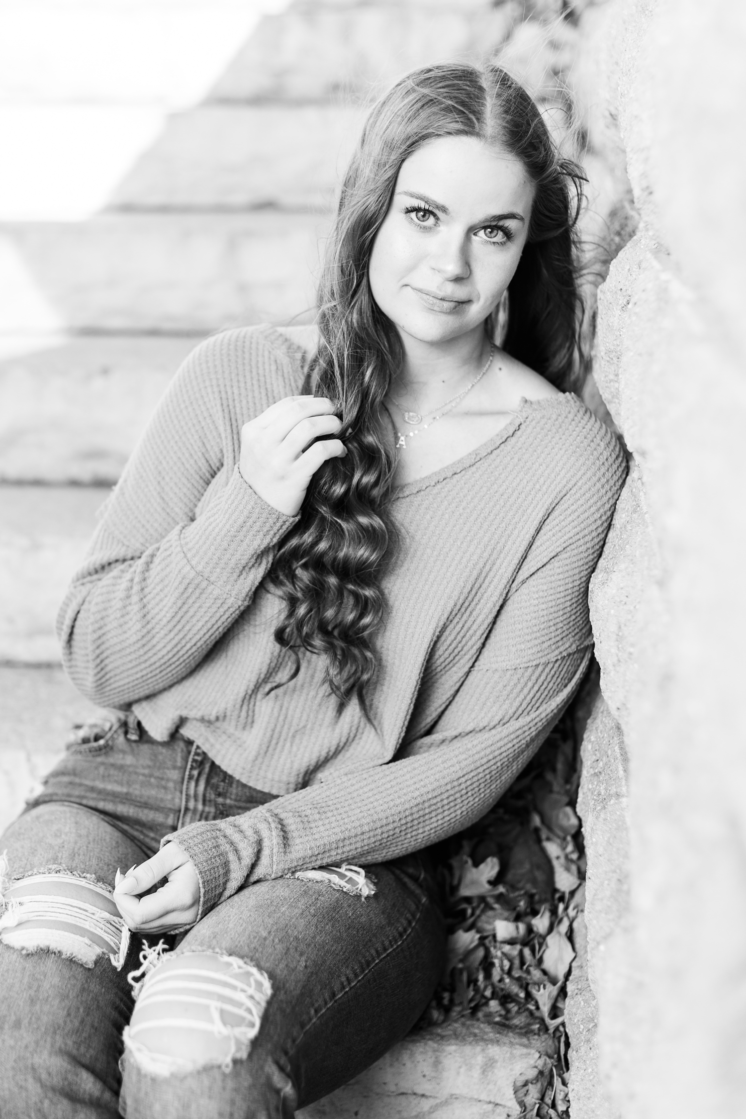 Avery sits and leans on a stone stairway | CB Studio