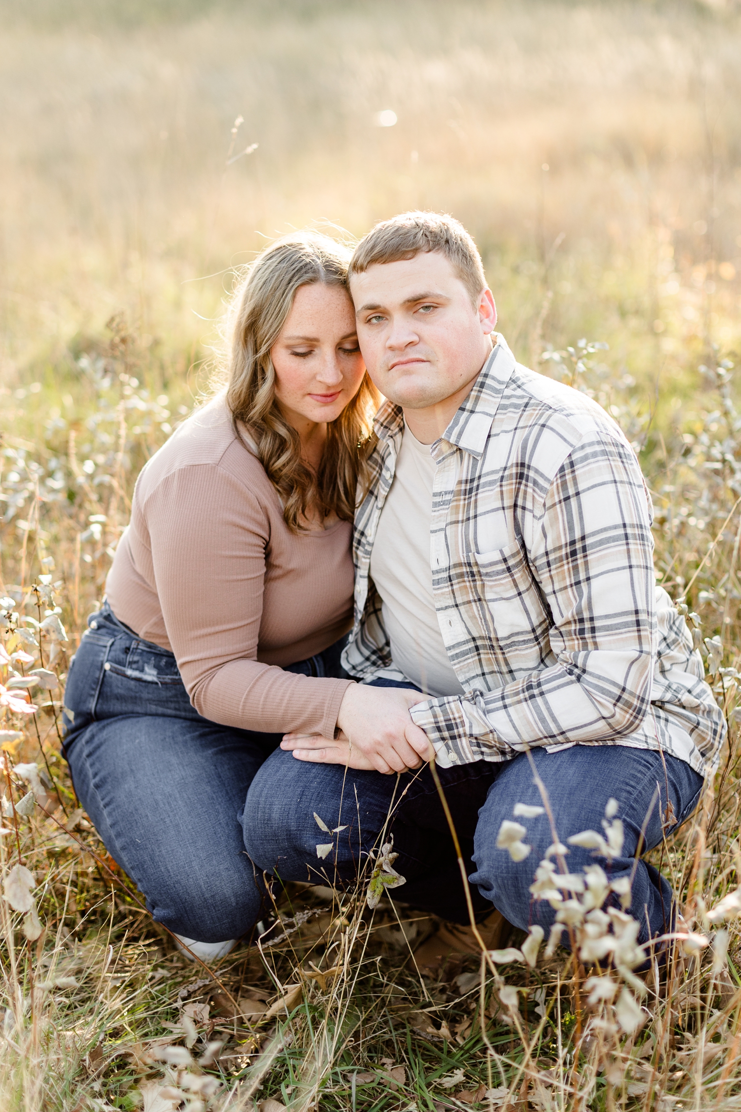 Shelby and Taylor squat down together in a grass pasture in Iowa | CB Studio