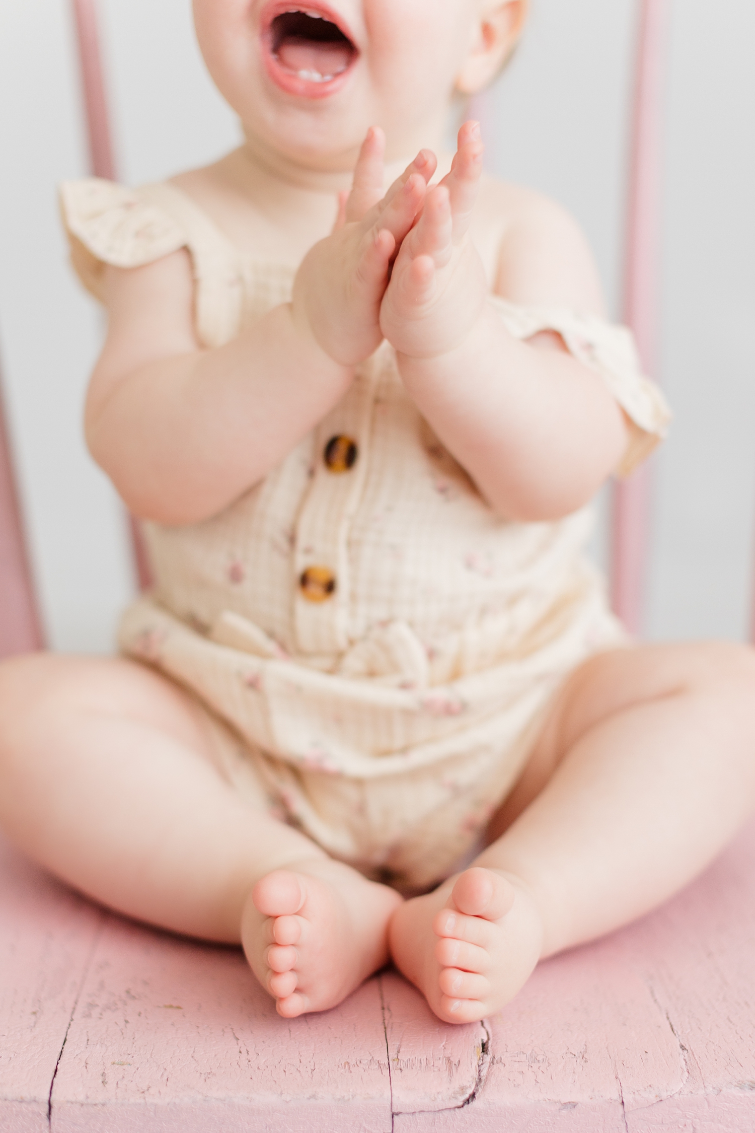 Closeup details of baby Shae as she claps her hands and smiles | CB Studio