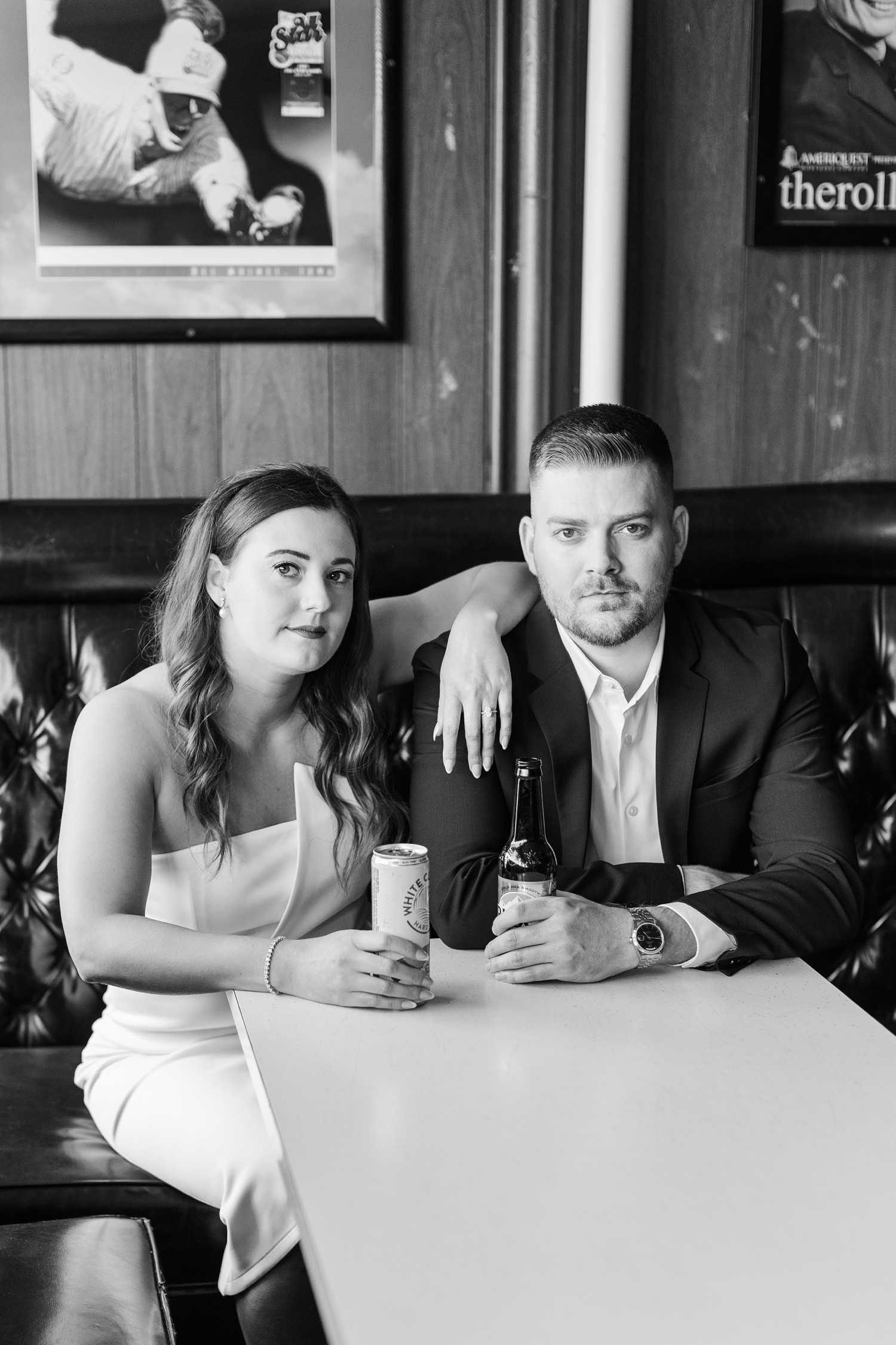Jenna and Dustin sit in a black booth at the Alpine Taproom in Des Moines, IA | CB Studio