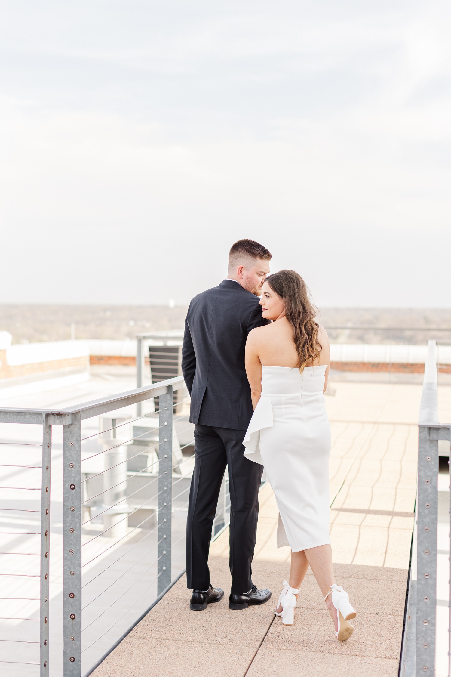 Jenna and Dustin walk along the rooftop of the The Equitable Building in Des Moines, IA and pause to look at the view of the cityscape | CB Studio