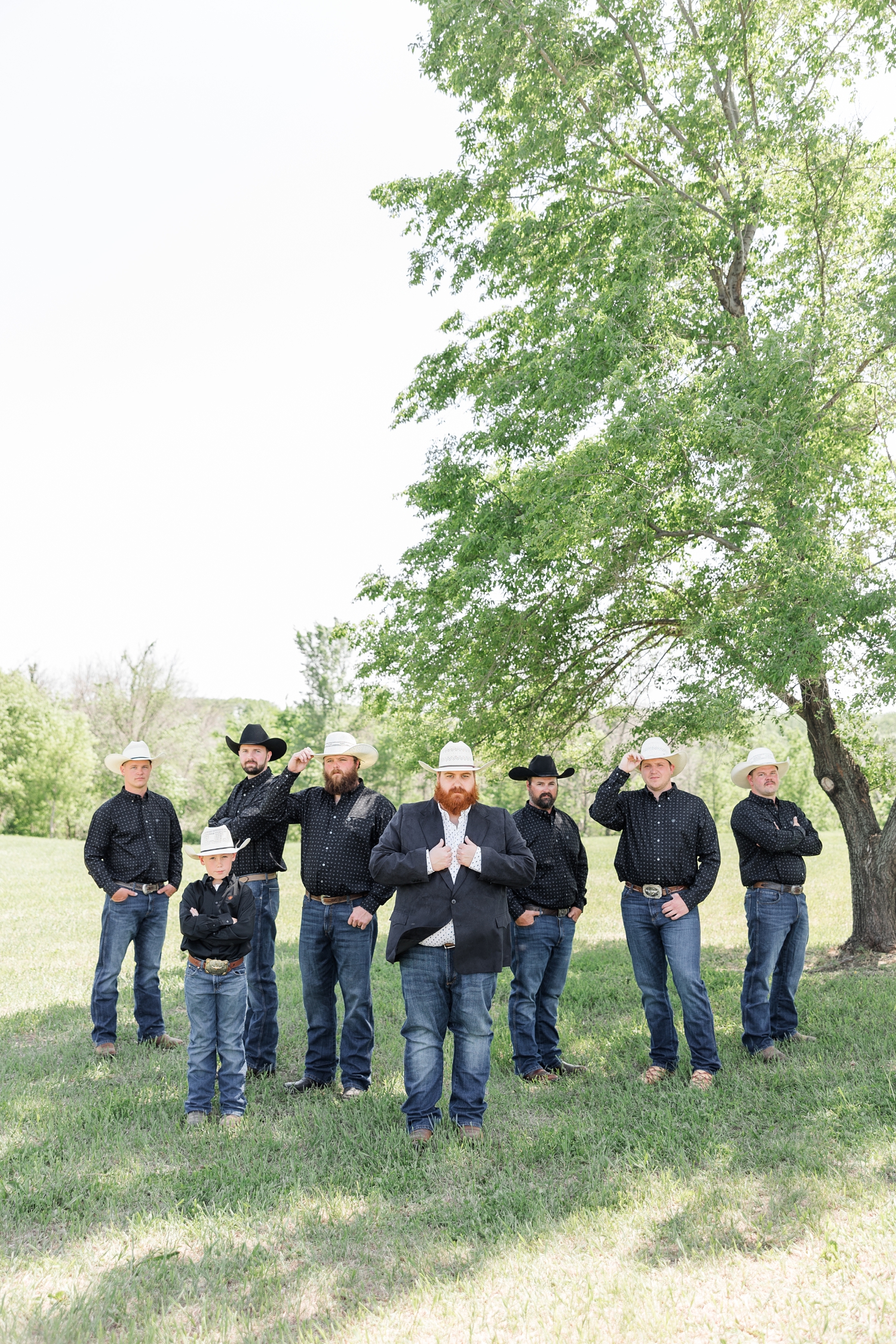 Trent poses stoically with is groomsmen all wearing western attire at Lizard Creek Ranch in Fort Dodge, IA | CB Studio 