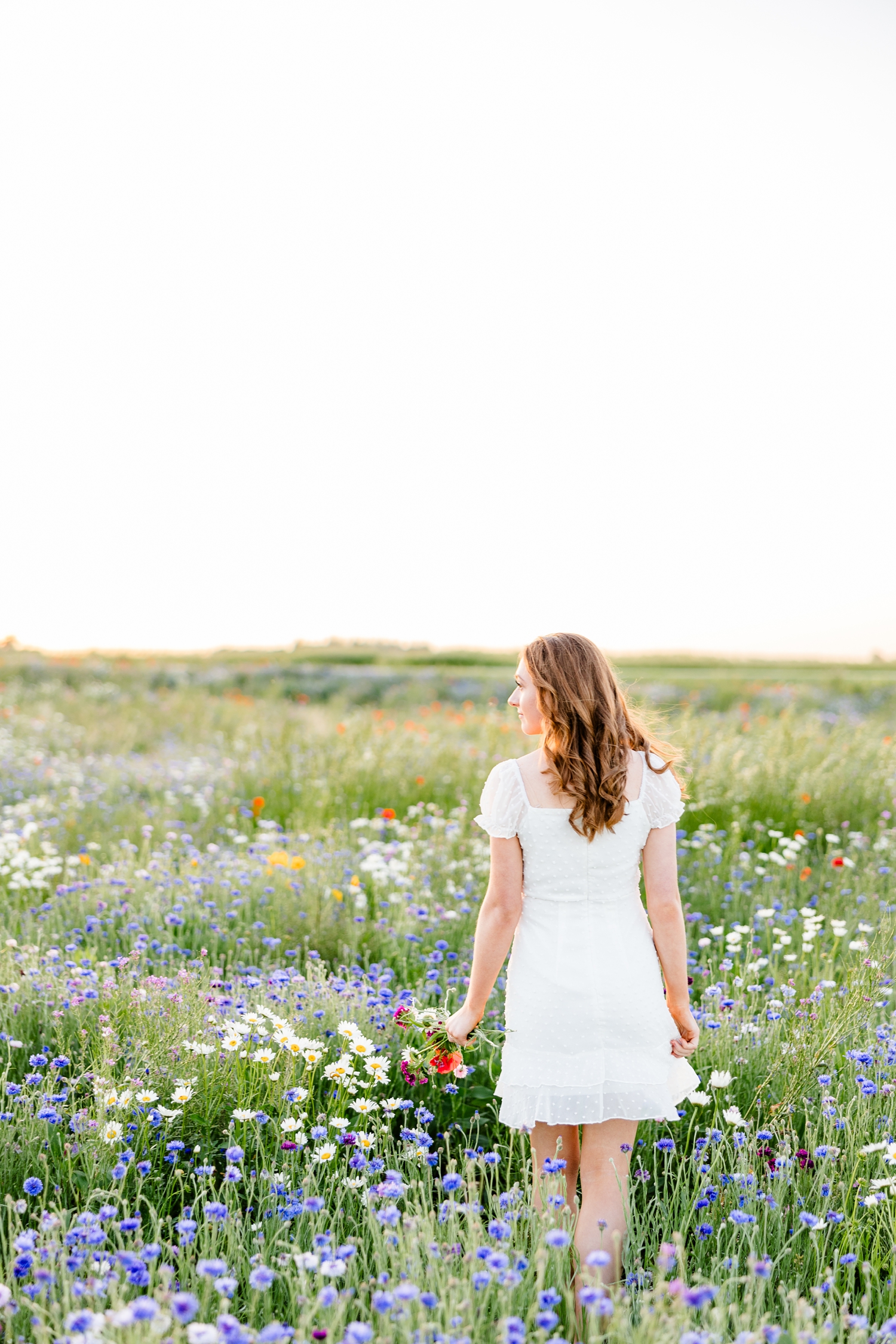 Izzie walks away in a filed of wildflowers | CB Studio