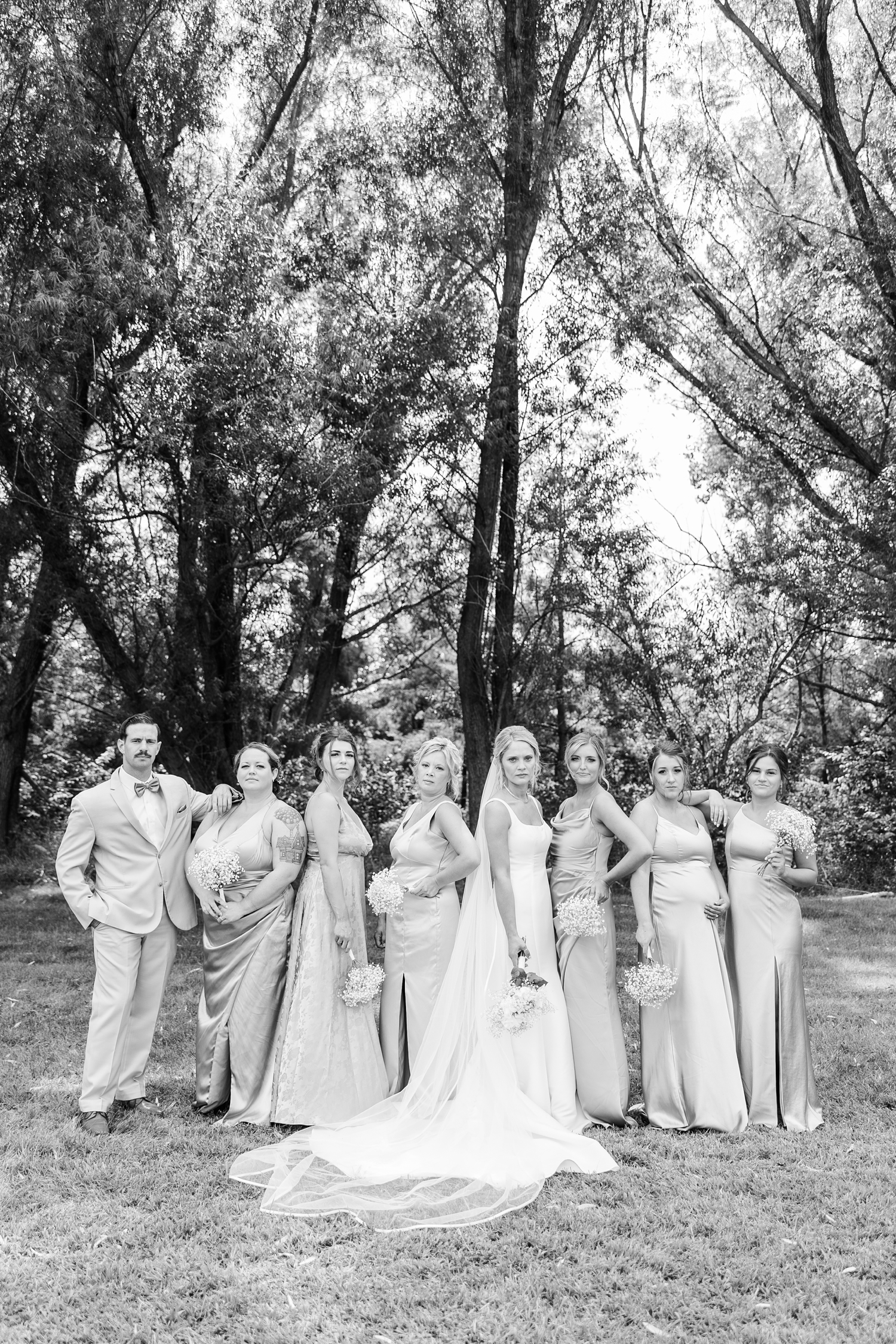 Nicole and her bridesmaids stand in model poses while blank staring at the camera | CB Studio