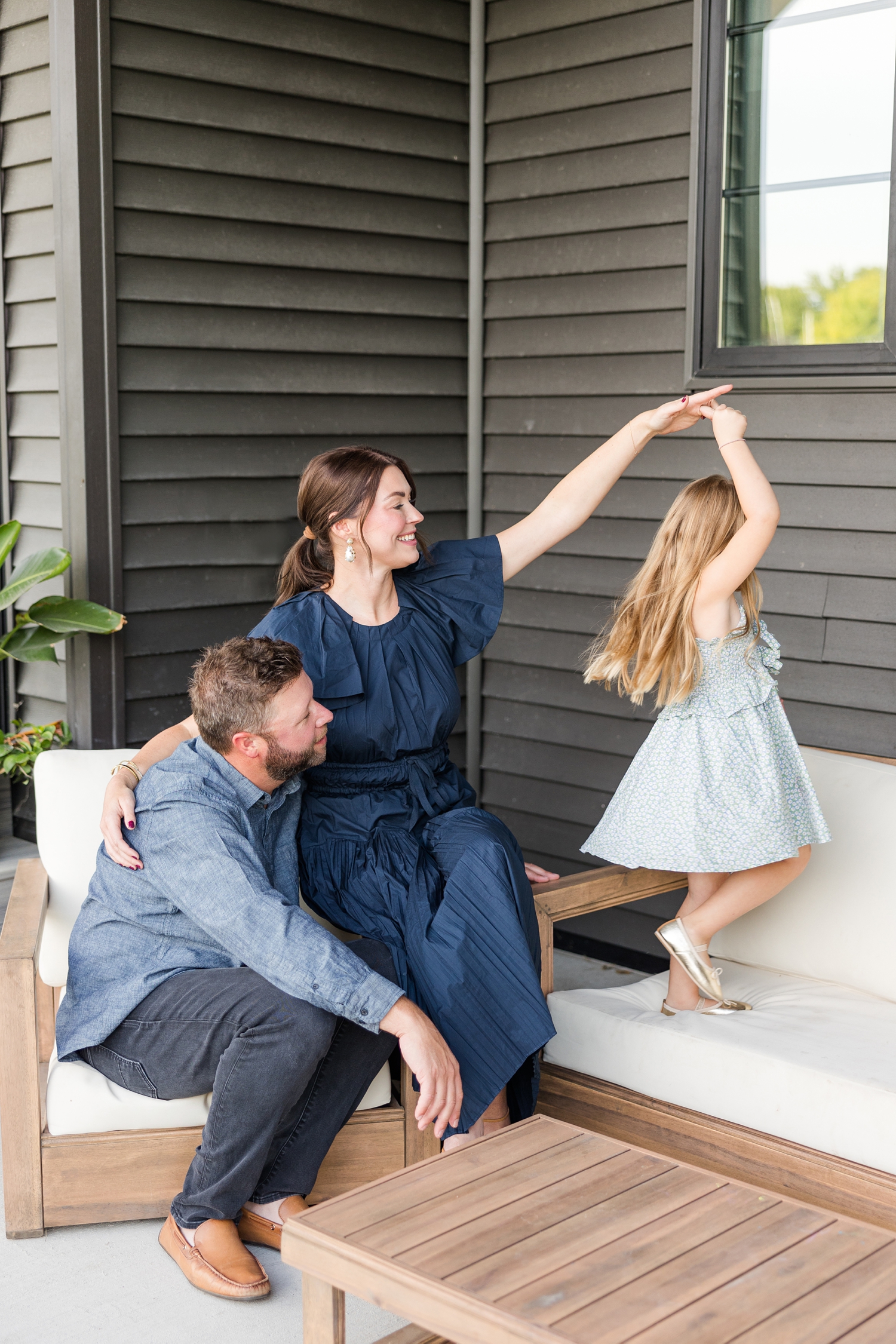 The Arndorfers sit on their back patio in their new, modern home for an in-home lifestyle family photoshoot | CB Studio