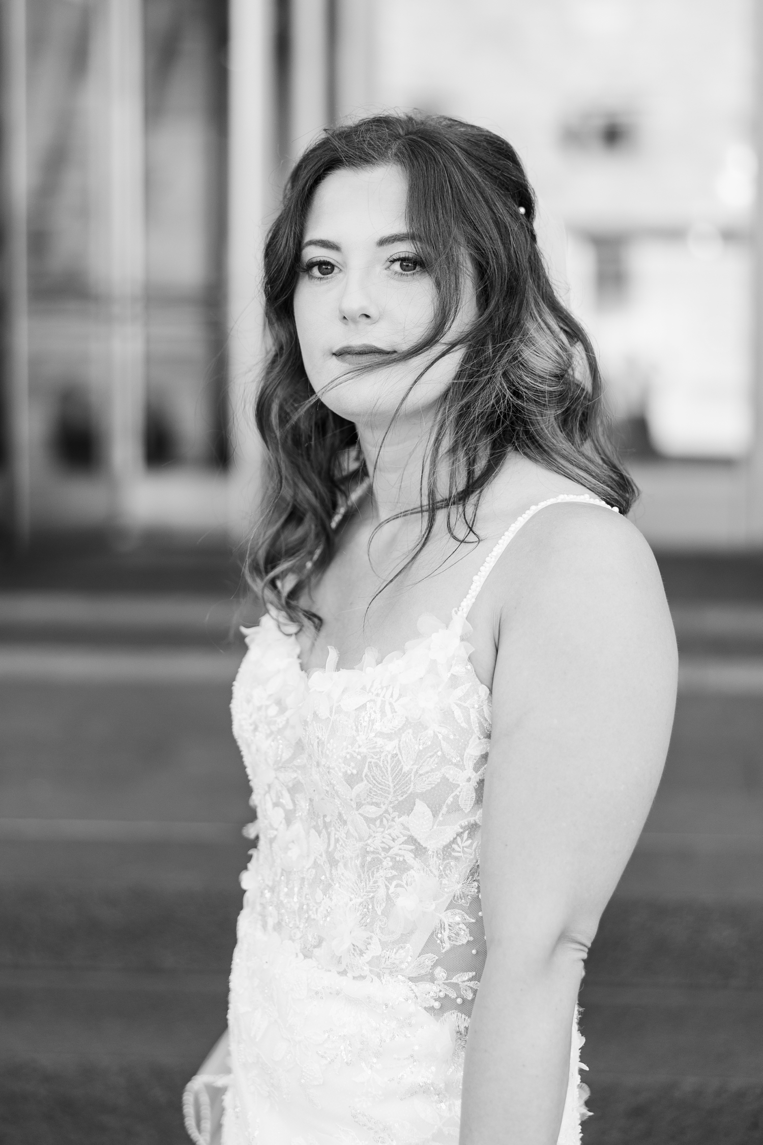 Jenna stares intently as she stands on the steps of 801 Grand in downtown Des Moines | CB Studio